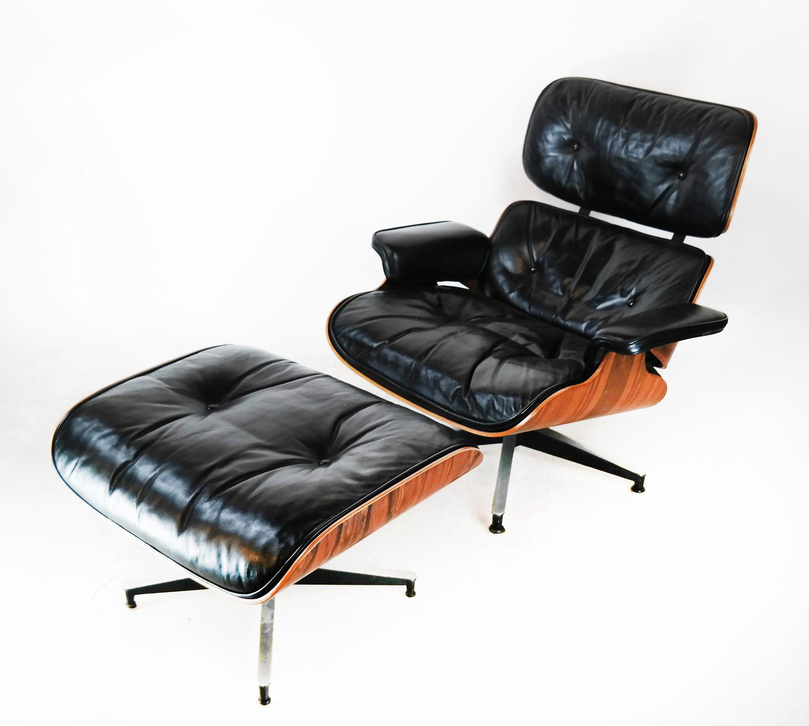 Charles Eames Herman Miller Chair & Ottoman: Rosewood laminated swivel chair and ottoman, by Herman Miller. Ottoman not marked. [32" H x 33 1/2" W x 30 1/2" D; 12" to seat].