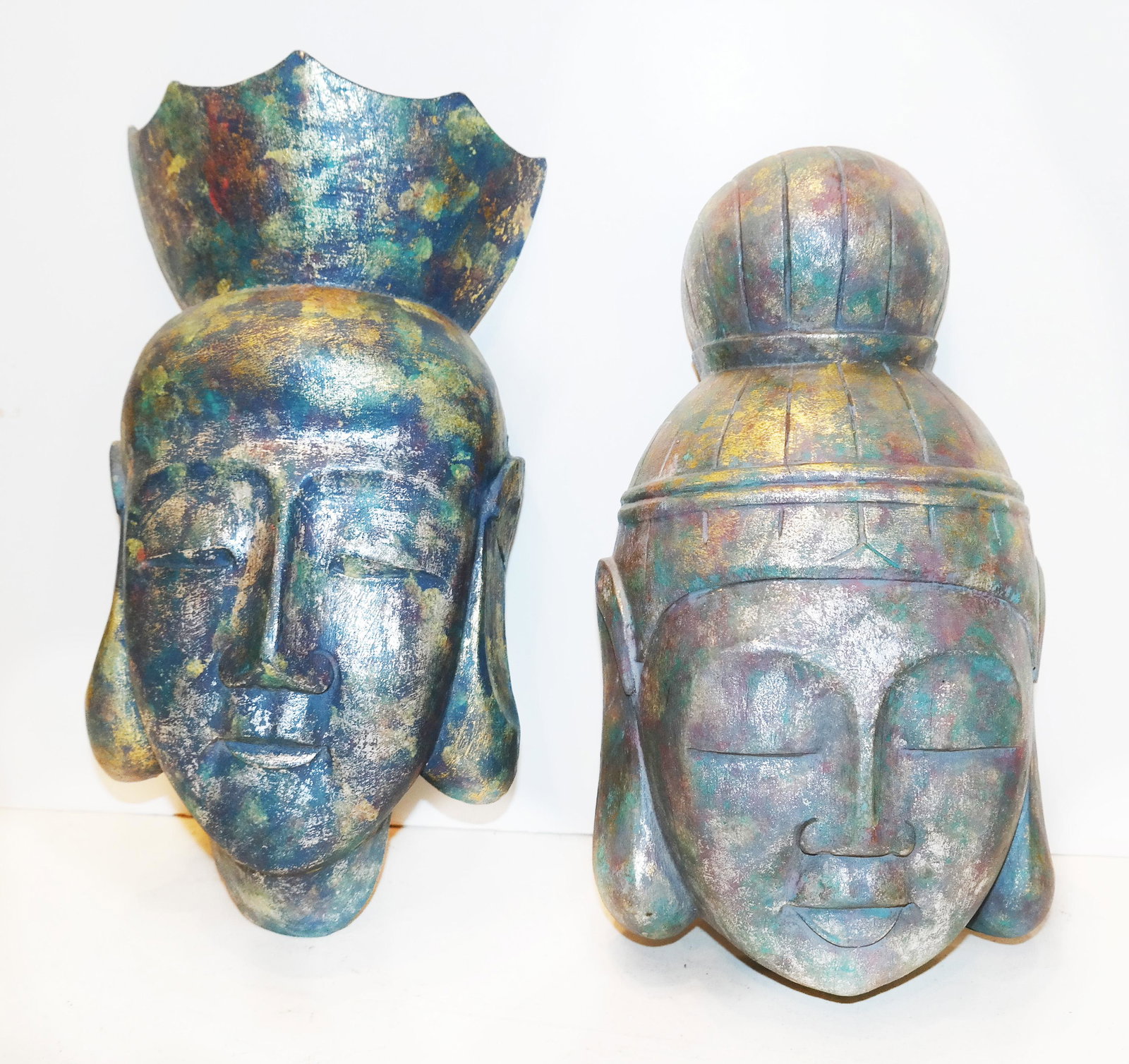 Pair of Indonesian Deity Heads: Pair of 20th century Indonesian wall-hanging deity heads, in carved, painted and gilt wood. [Each: 12" H x 7" W x 4" D]. In good condition.
