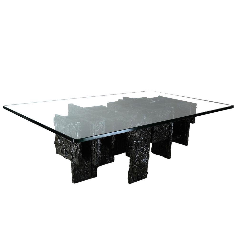 Paul Evans Brutalist Coffee Table: 20th century modern coffee / cocktail table, the base of wood and plaster, painted black, having a glass top. [Base: 15 1/2" H x 47 3/4" W x 29" D; Top: (approx.) 60" L x 36" W].