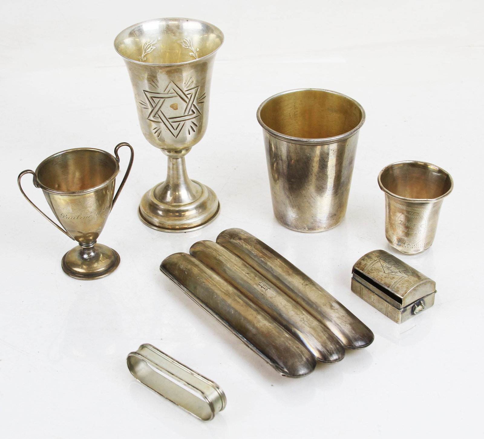 Lot of Sterling & Silver Articles: Silver lot includes four (4) German silver cups and a pill box, a sterling silver cigar box with "M" monogram [5" L x 2 1/2" W], and a Kiddush cup [4 3/4" H x 2 1/2" Diam.]. Total weight 9.225 ozt.