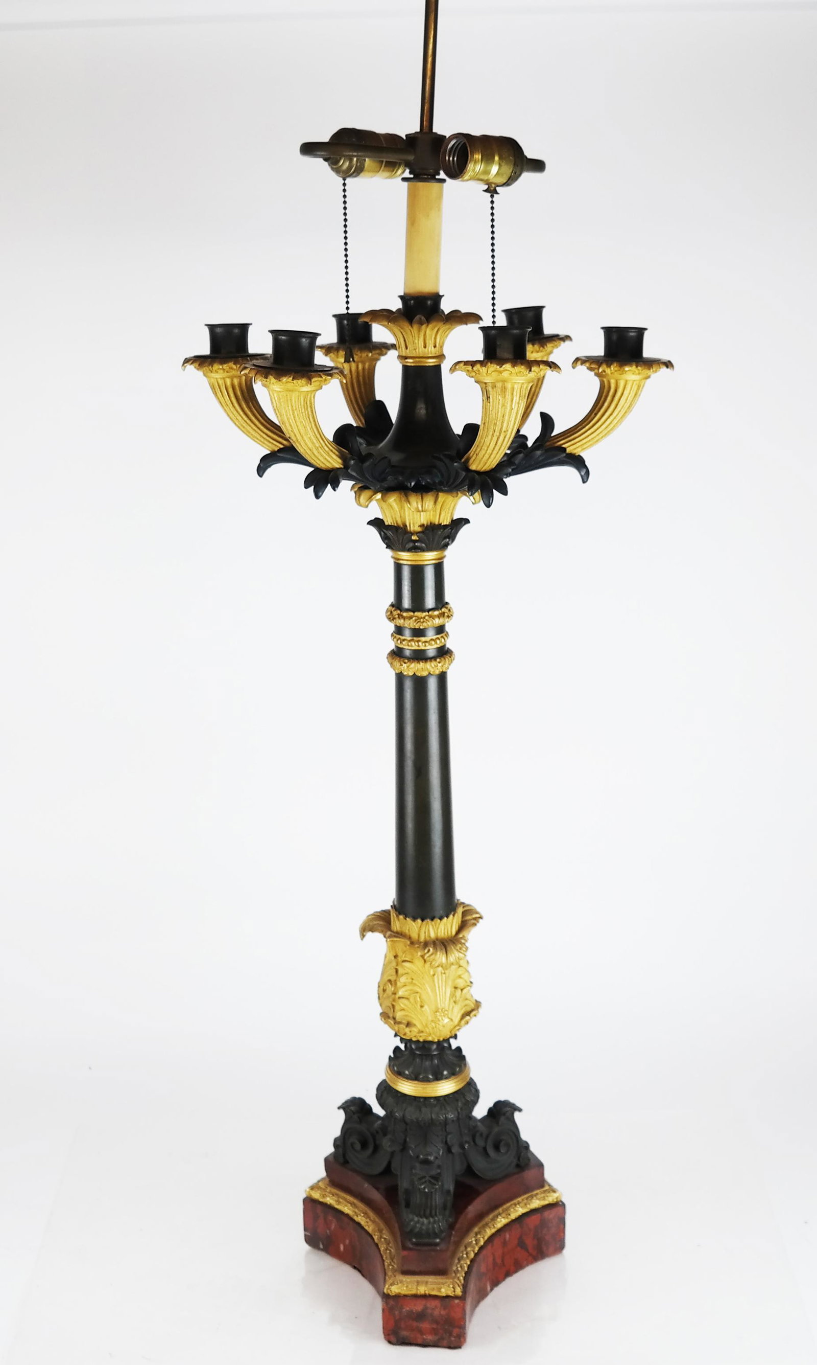 19th C. French Candelabra Lamp: Single bronze dore, black patina, rouge marble eight-arm night light candelabra. From 303 E. 57th Street NYC. [34" to socket x 13" Diam. (top) x 8" Diam. (base)]. In good condition.