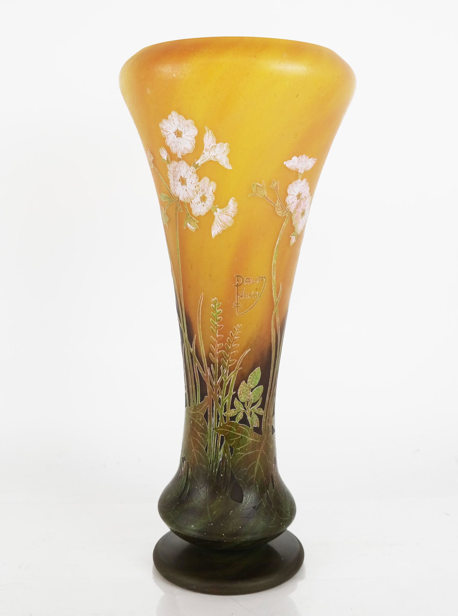 Late Daum Nancy Tall Footed Cameo Vase: Late production Art Nouveau-style, acid etched cameo glass vase with wild flower motif, signed in cameo "Daum Nancy" at upper center. [16 1/8" H x 7 1/2" Diam.].