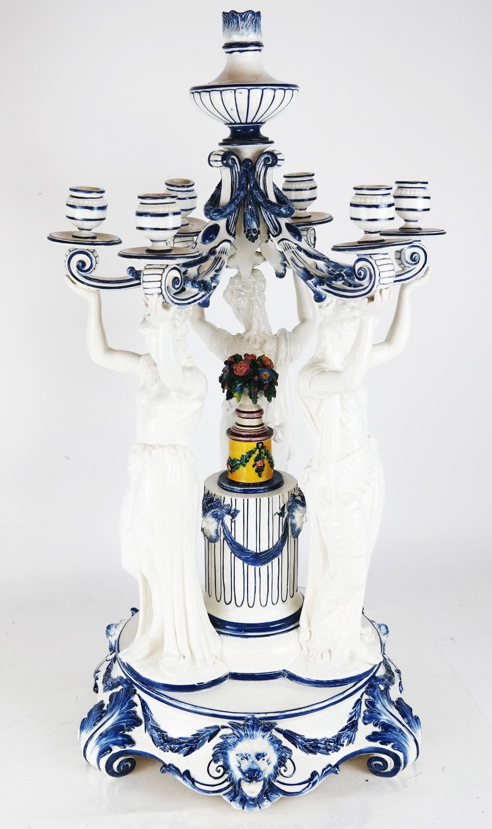 7-Light Porcelain Continental Candelabra: Mid 19th century Continental Neoclassical porcelain candelabra, designed with three maidens supporting the candelabra, surrounding a column with painted flowers, having three lion's masks around the b