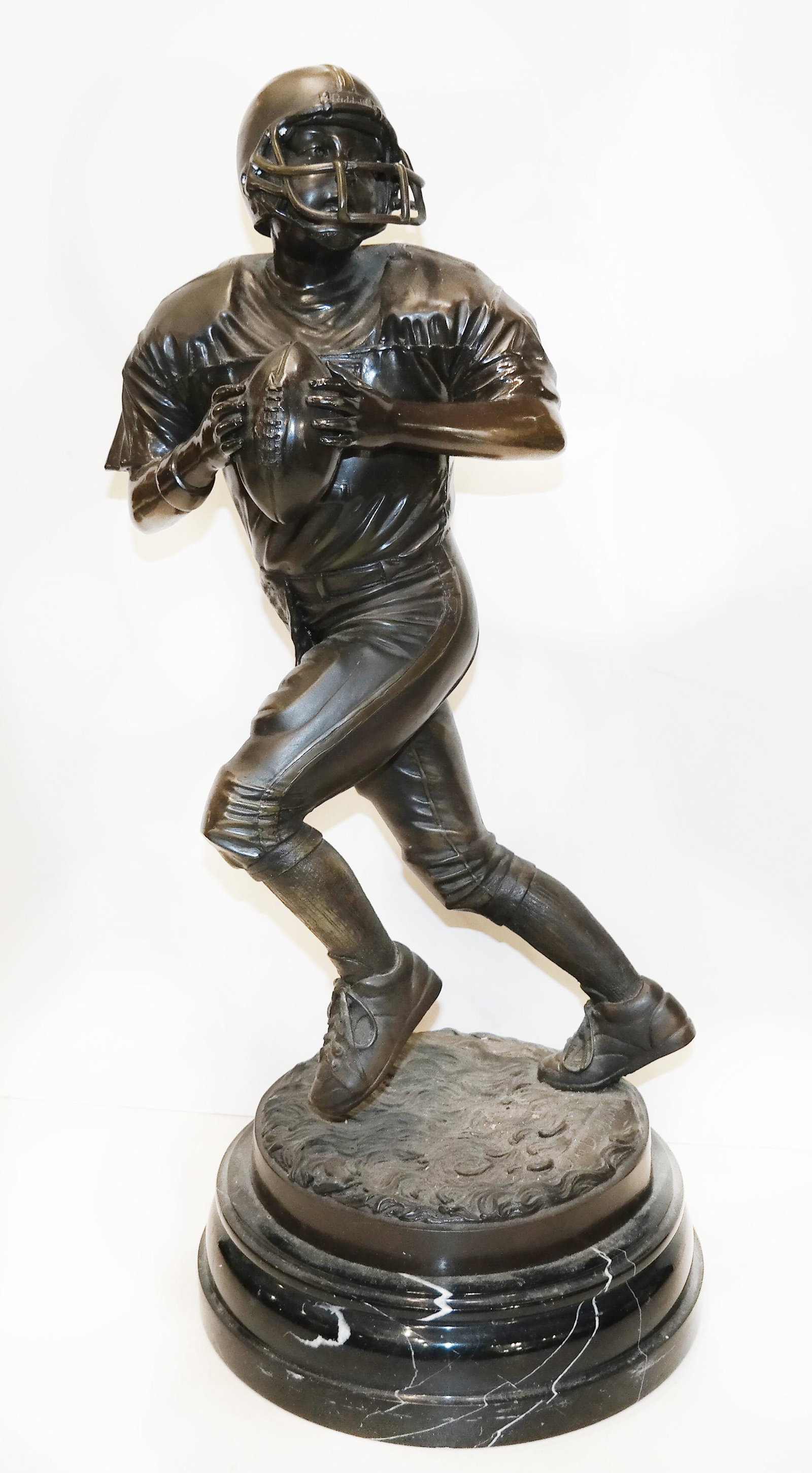 Jim DAVIDSON: Football Player - Bronze: Cast bronze sculpture of a running football player about to throw the football, signed on the base. [25" H x 10 1/2" Diam. (base)].