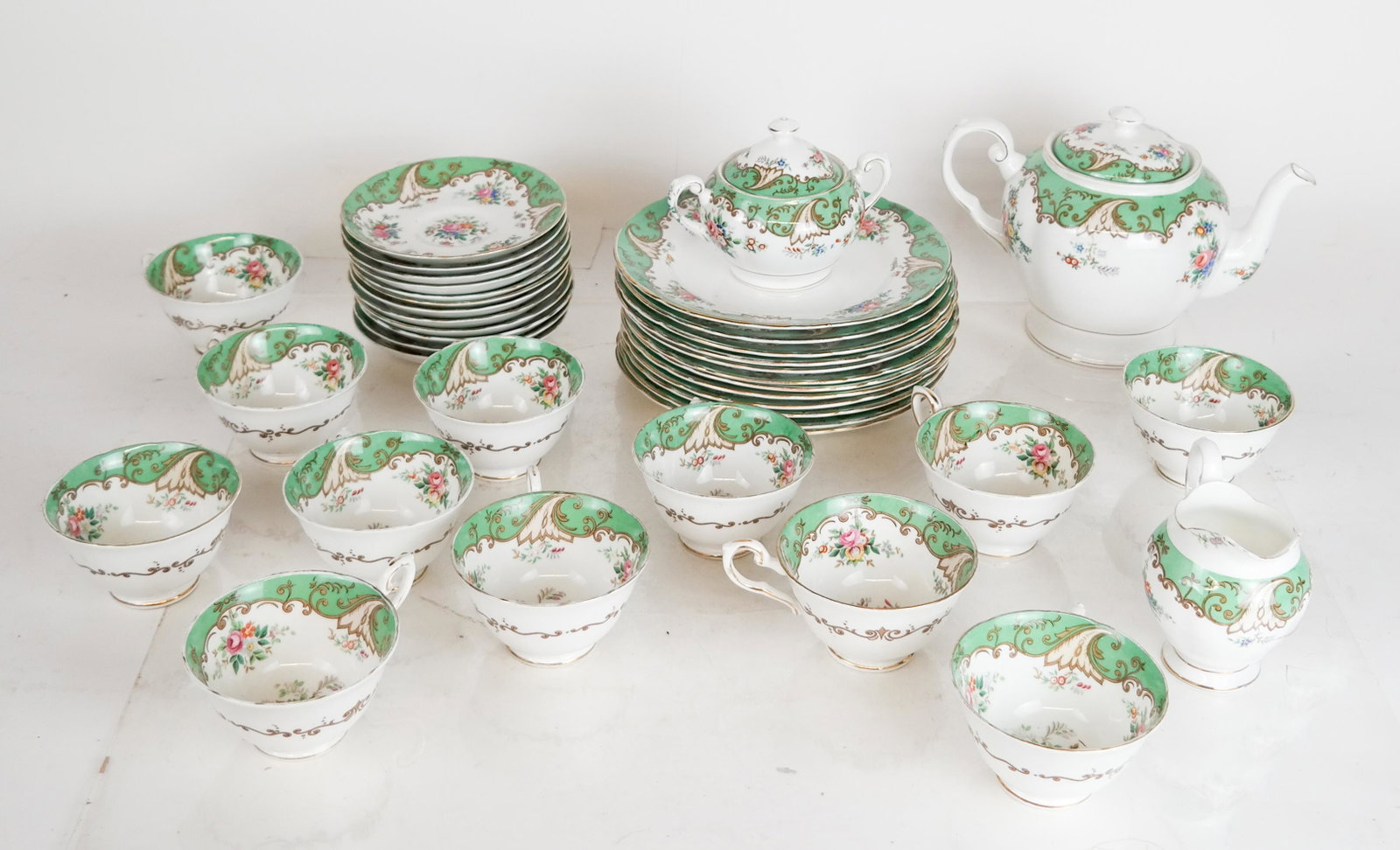 Tuscan Dinnerware - 39 Pcs.: 39-piece porcelain dessert service, "Blenheim", including 12 dessert plates [8 1/4" Diam.], 12 teacups, 12 saucers, a teapot, sugar and creamer. [Tallest: approx. 7" H]. All in good condition.