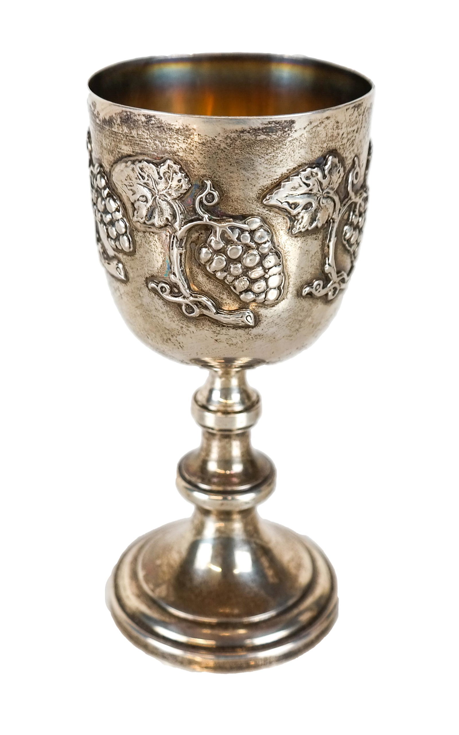 Sterling Silver Kiddush / Wine Cup: Sterling silver kiddush cup, with grape cluster and vines relief decoration. 4.865 ozt. [6" H x 2 3/4" Diam.].