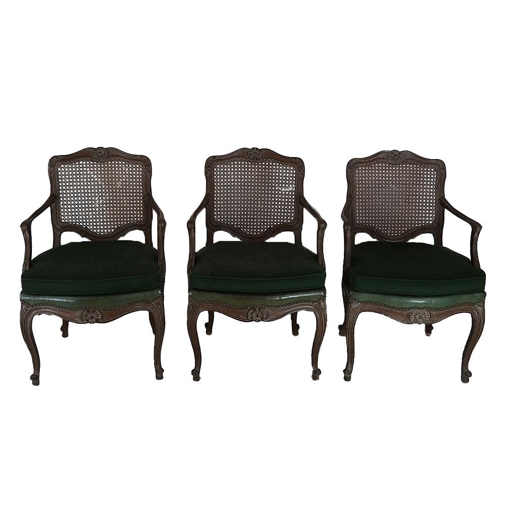 Group of Three Caned Arm Chairs: Group of 3 carved walnut caned back arm chairs. [33" H x 21" W x 17" D].