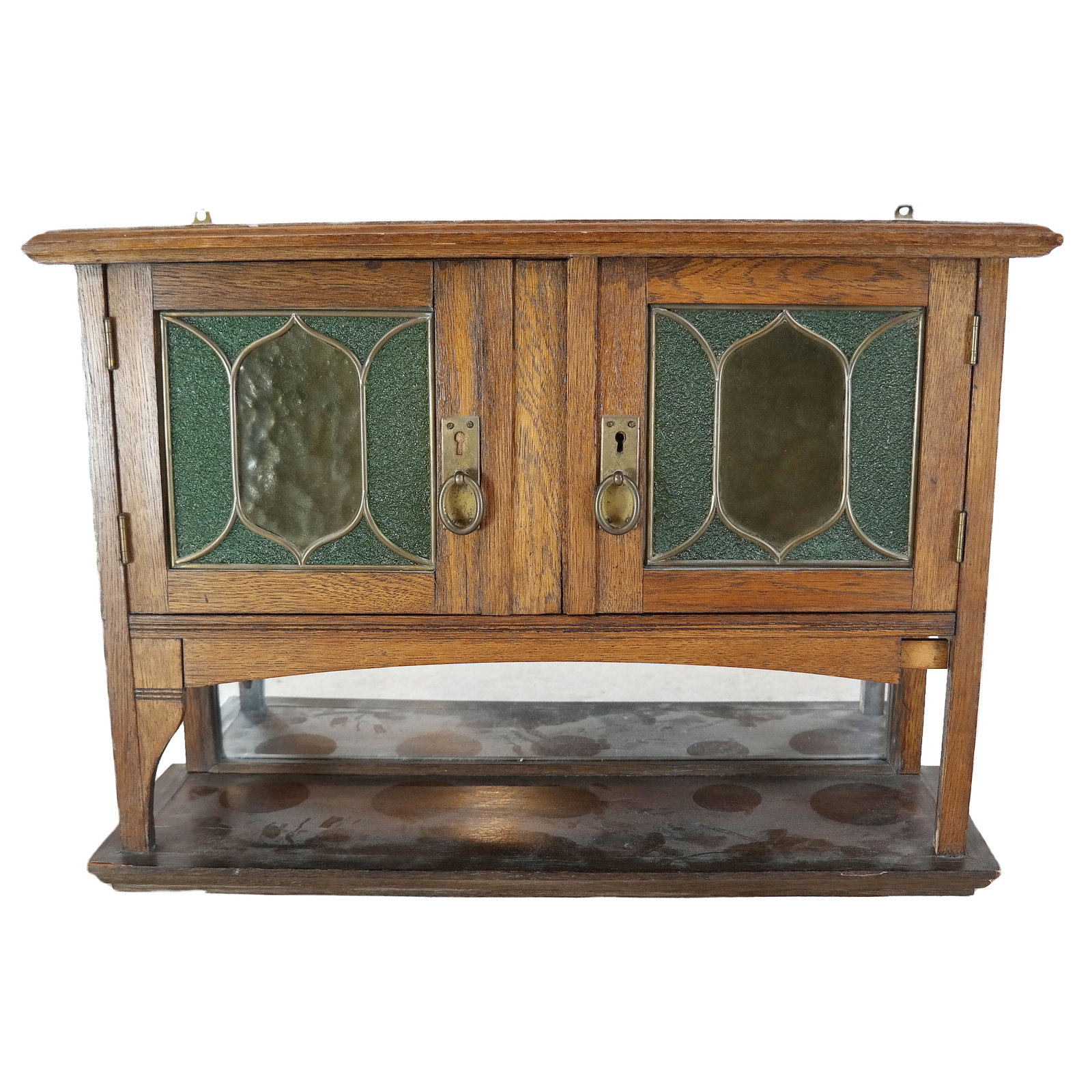 Arts & Crafts Oak Hanging Cabinet: Two-door cabinet with lead glass inserts and a lower mirror-back tier. [18" H x 26" W x 9" D]. In good condition.