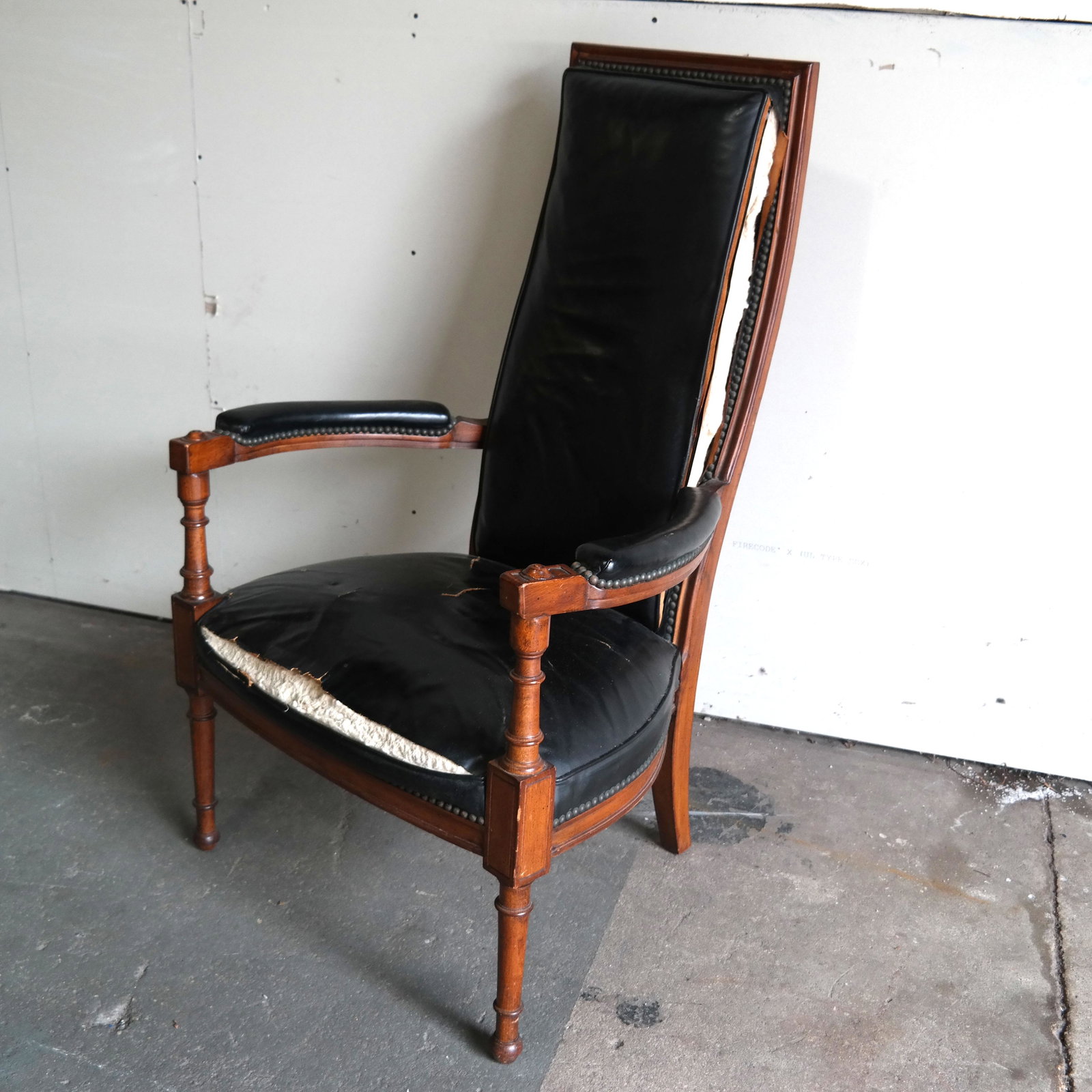 Directoire-Style Tall Back Open Arm Chair: Open arm chair with leather upholstery on fruitwood frame, having rounded, open arms, on tubular legs. [47" H x 29" W x 30" D]. Upholstery as-is.