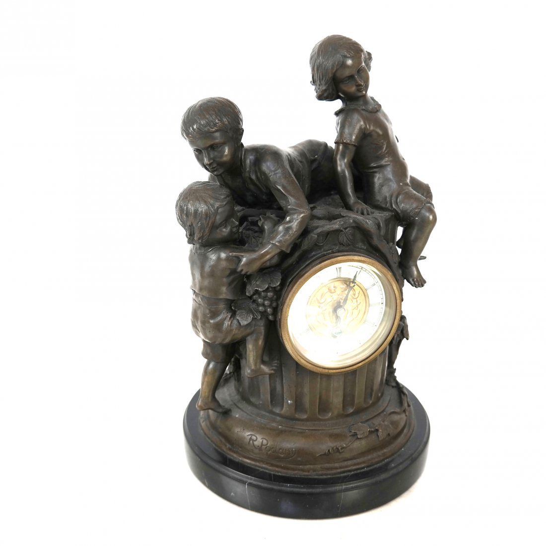 French-Style Bronze Clock: Clock depicting three playful children atop a column post, with interior works. [15" H x 10' W x 9" D].