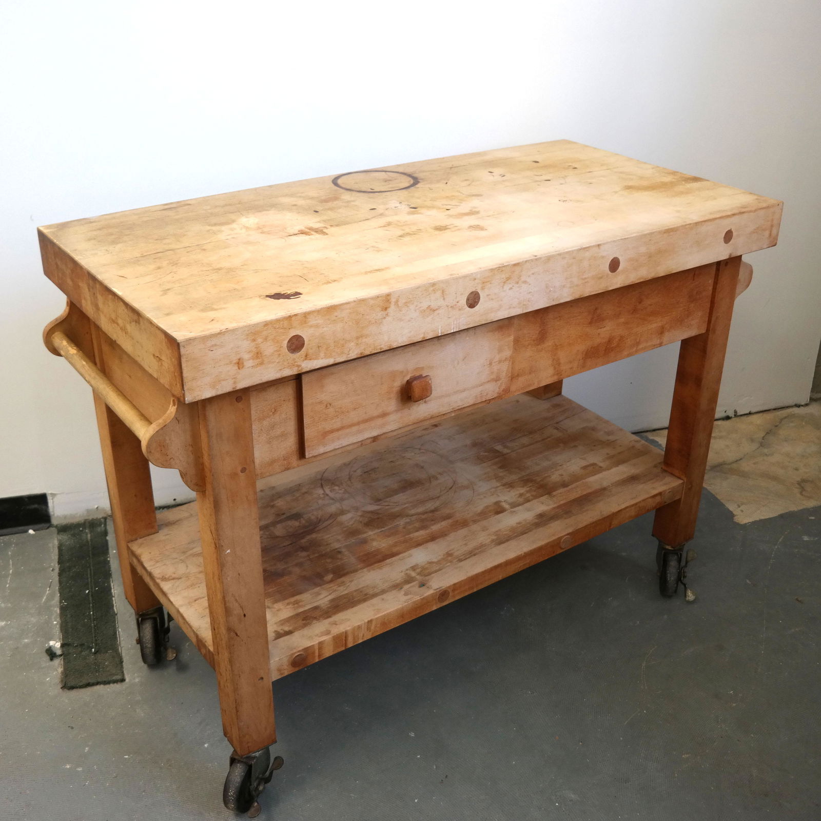 Butcher Block Serving Cart: Two tiers with opposite side drawers on top, on locking wheels, with handles. Maple ??[37" H x 52" W x 24" D]. Stains - wear