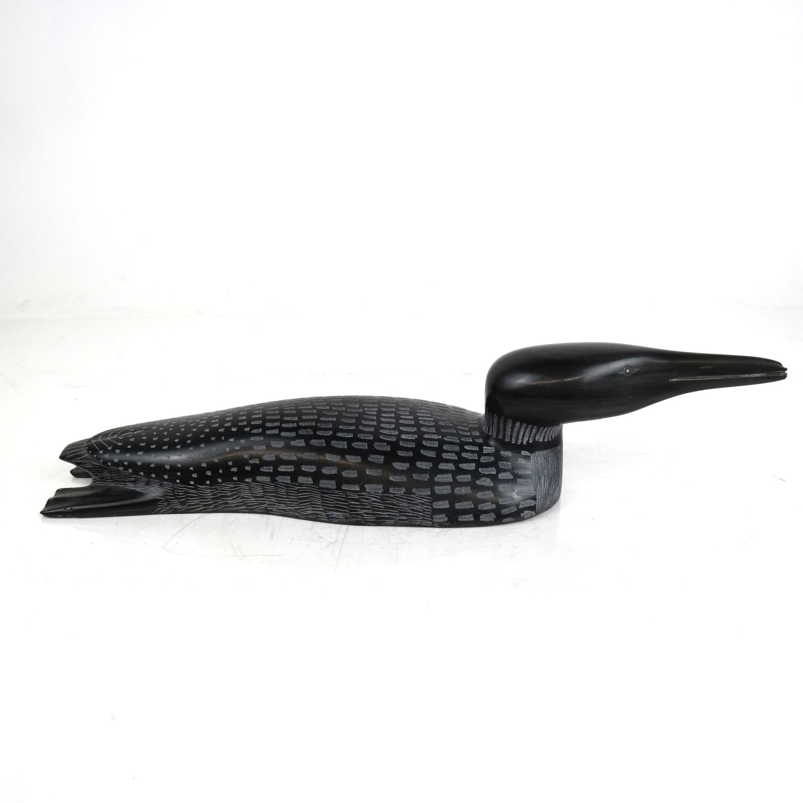 Carved Soapstone Swimming Bird: Carved soapstone swimming bird. [3 1/4" H x 15 1/4" W x 4" D]. Tiny chip on beak.