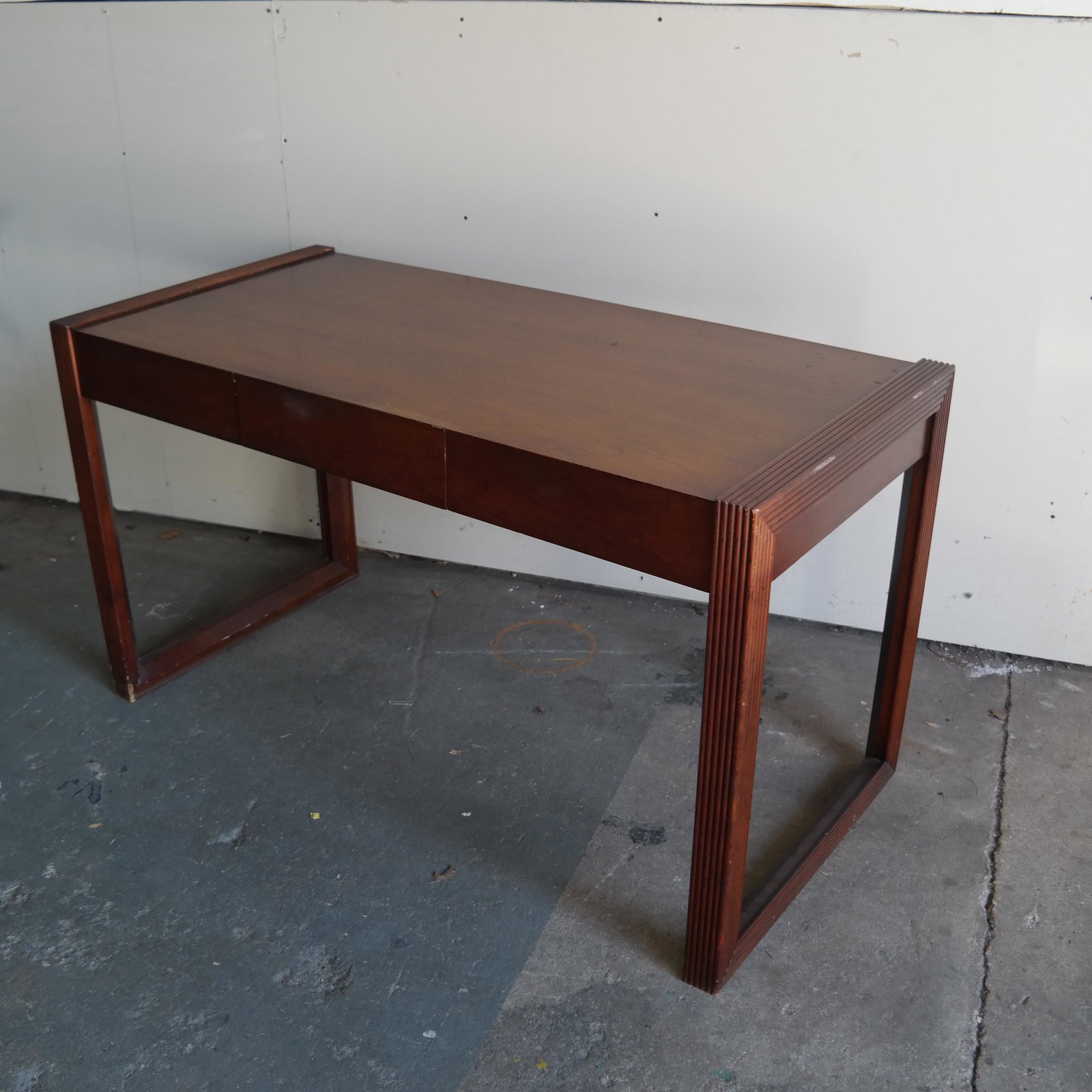 Mid-Century Table Desk: Mid-century table desk, with reeded side supports and three drawers. [30" H x 54" W x 26" D].