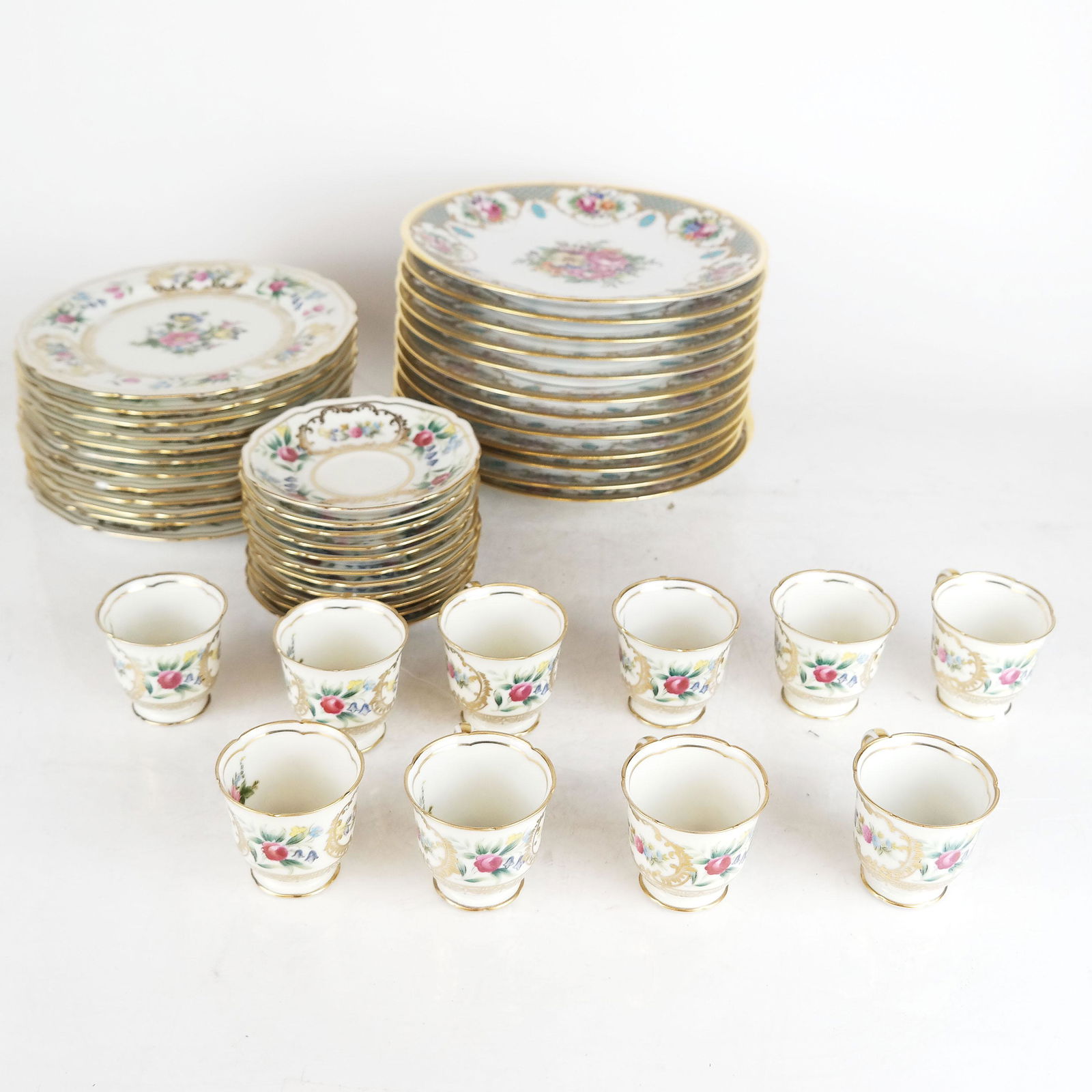 Two Mixed Dinnerware Sets: Two porcelain dinner sets: 1) Noritake "Dresolin" pattern including 12 dessert plates 11 saucers, 10 demitasse cups (one plate chipped), and 2) 12 Dresden salad plates (in good condition).