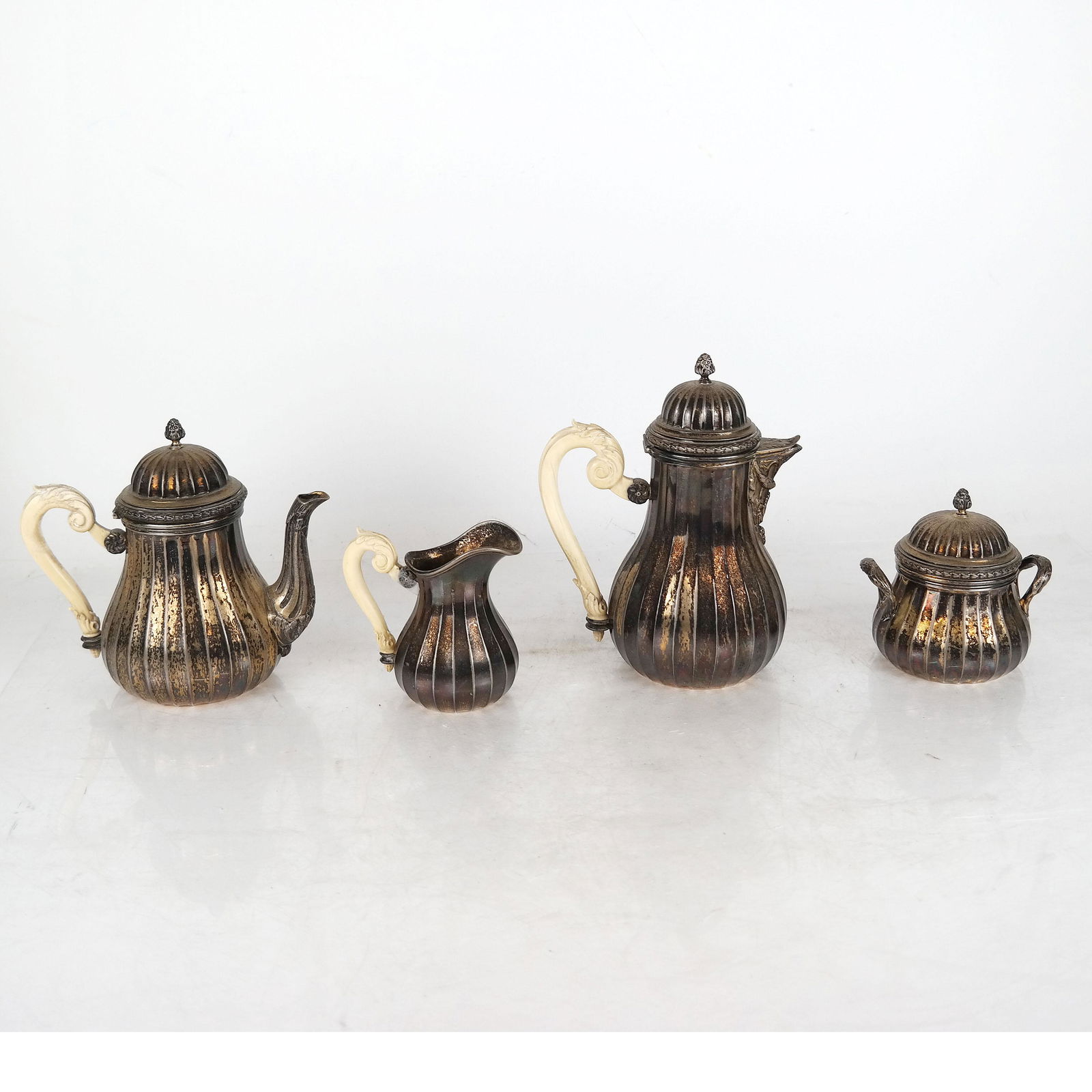 4-Pc. Sterling Silver Tea & Coffee Set: Sterling silver tea and coffee set with bone handles. Combined weight 51.86 ozt. [Largest: 7 3/4" H x 5 1/2" W x 3 3/4" D]. One handle needs re-gluing.
