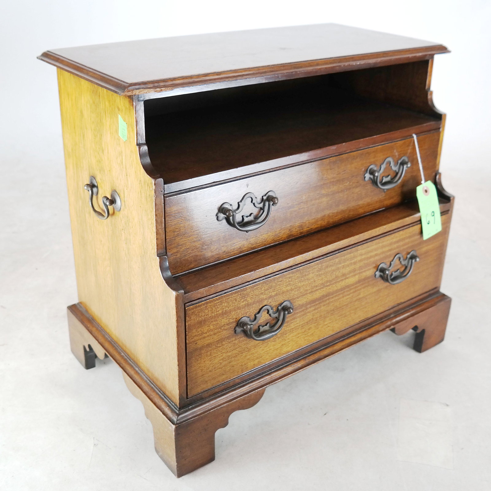George III-Style Mahogany Bedside What-Not: George III-style mahogany bedside what-not, with an open shelf over two drawers, on bracket feet. [19 1/2"H x 22" W x 13" D].