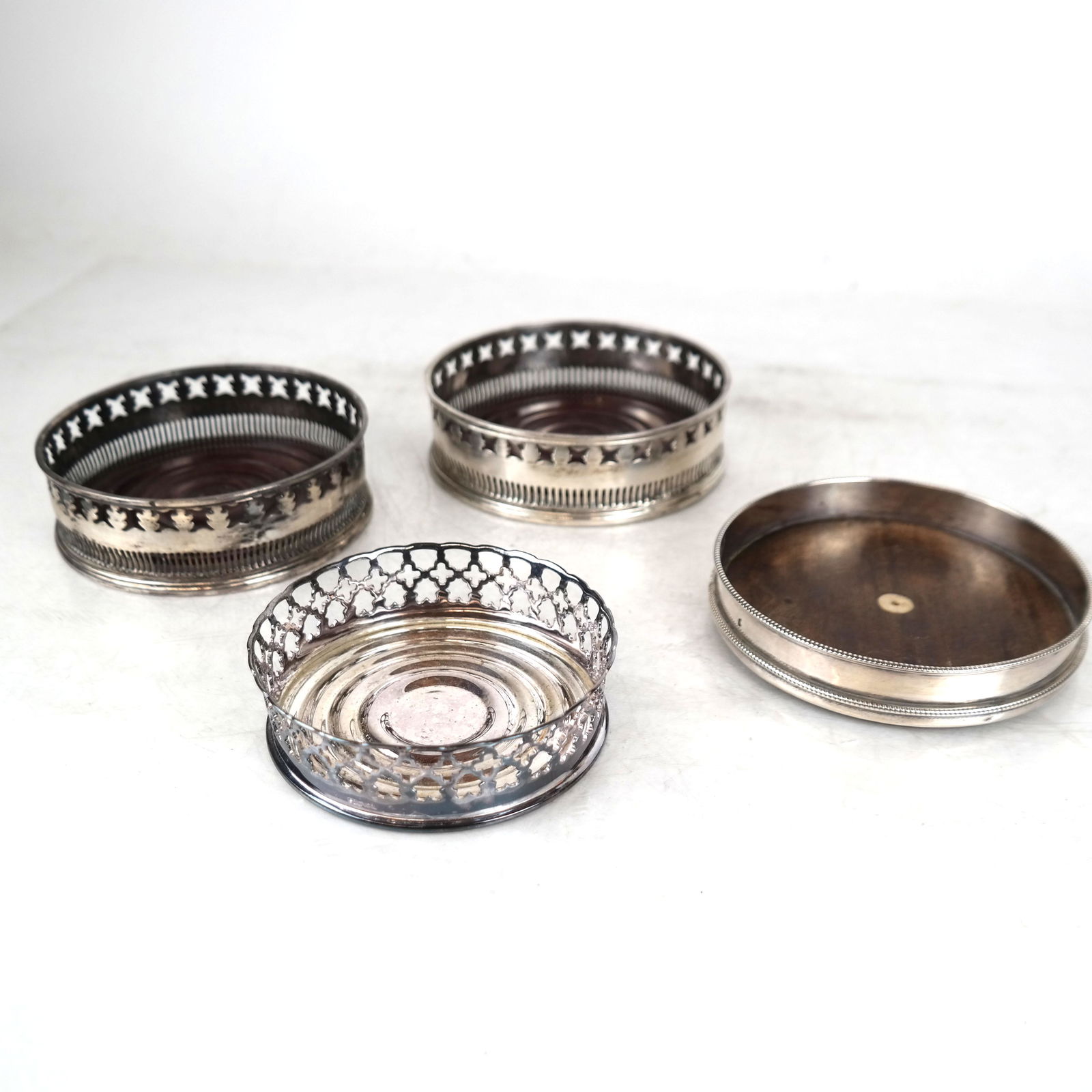 Four English-Style Bottle Coasters: Four English-style bottle coasters, one pair with illegible marks, one "London 1792" and one Portugal. New condition..