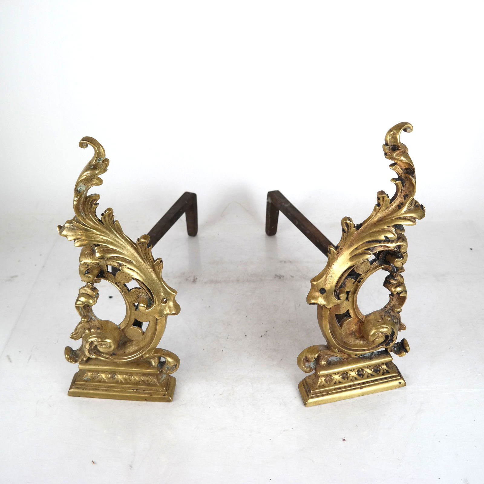 Pair Gilt Bronze Cartouche-Form Andirons: Pair of gilt bronze cartouche-form andirons. [13 1/2" H x 6" W x 15" D].