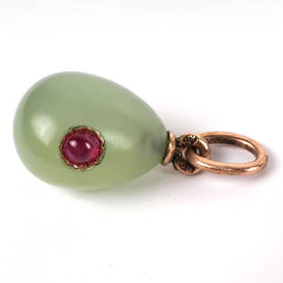 Faberge Egg Pendant: Faberge light green jade pendant, 1/2" long, with red ruby inset stone, stamped "K (?) 56". In good condition.