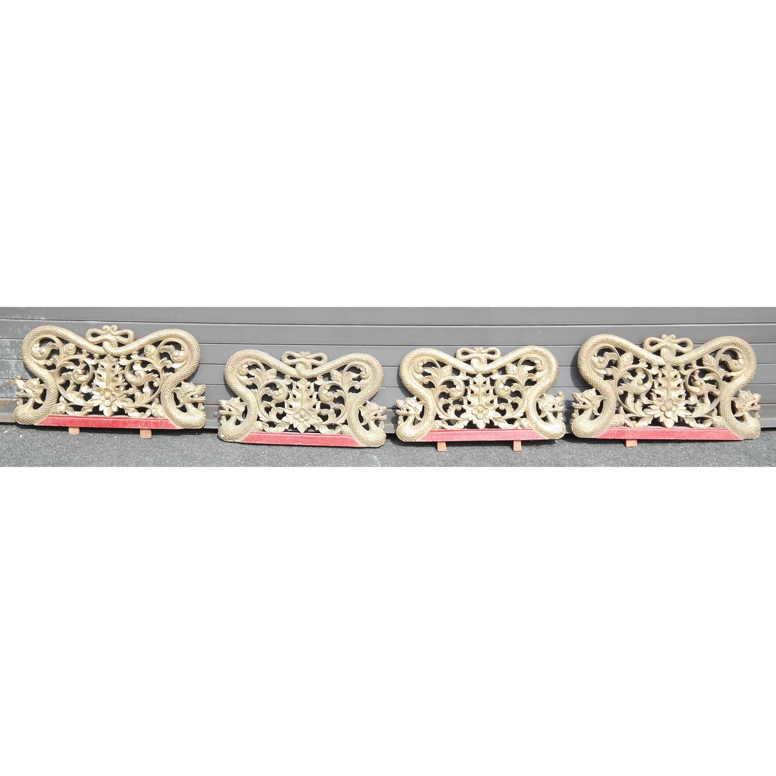 Set of Four Chinese Carved Pediments: Gilt carved pediments, decorated with serpents surrounding scrolls. [12" H x 23" W x 2" D].