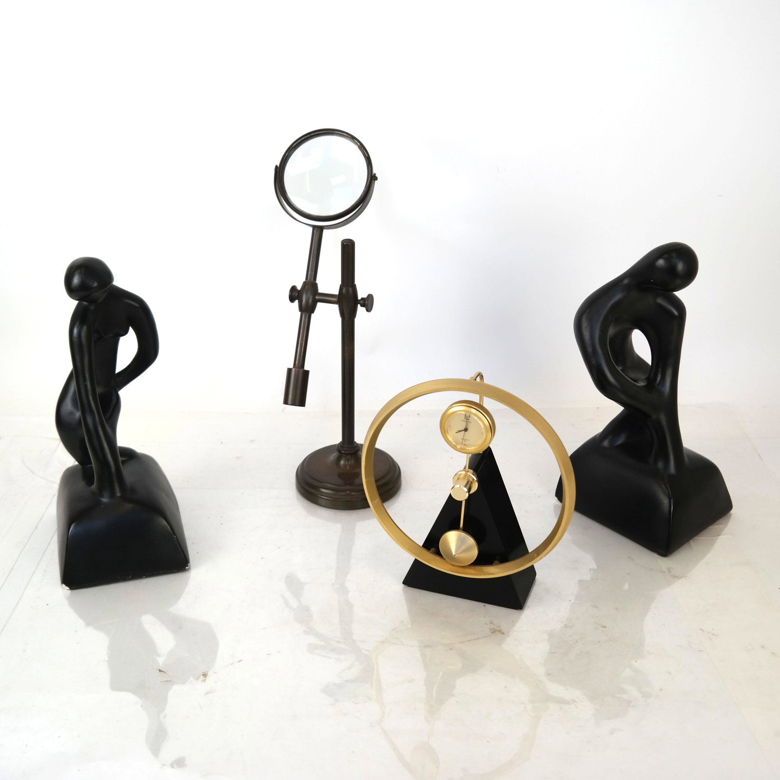 Four Table/Desk Decorations: Two composition figures: a clock and a magnifying glass.