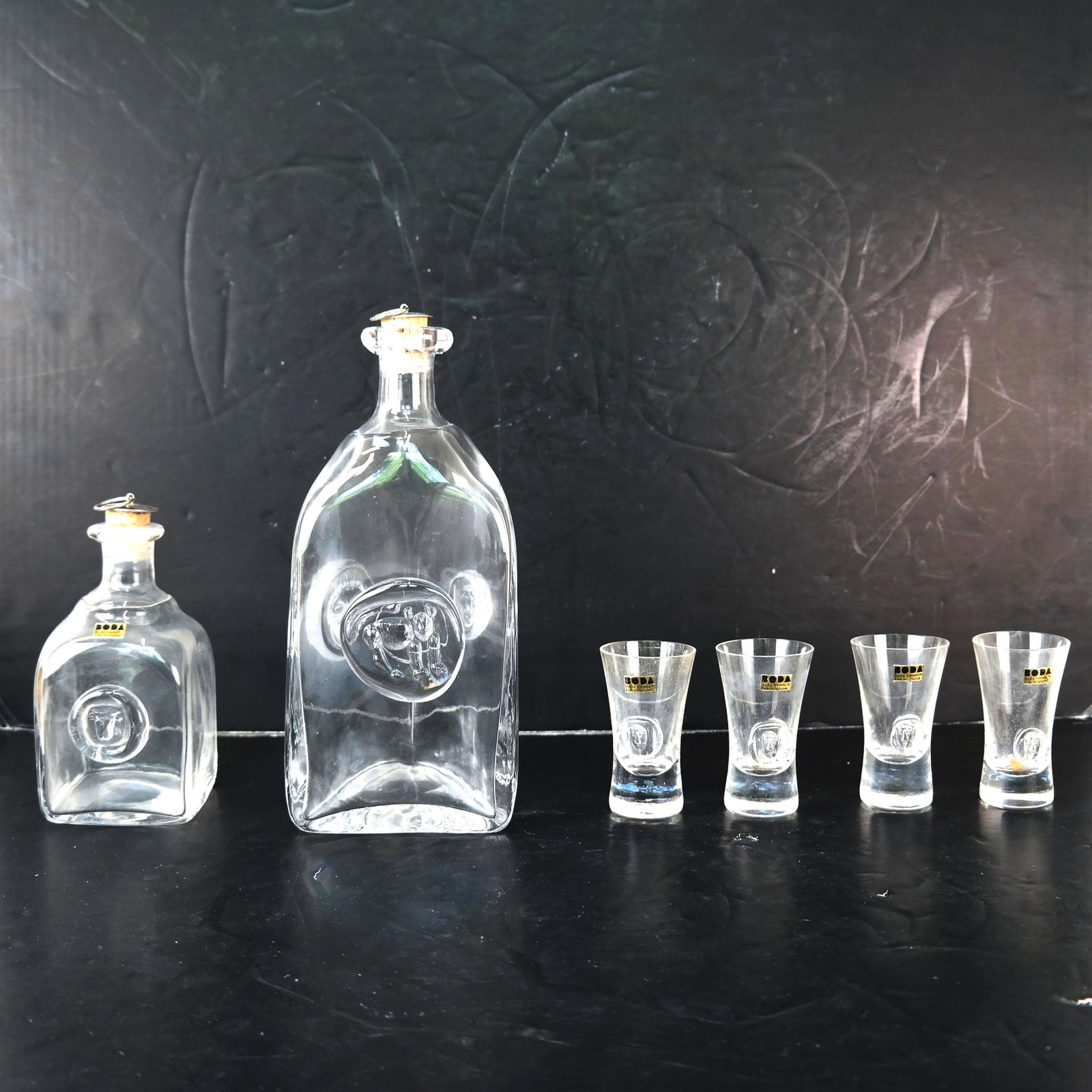 6-Piece Swedish Triangular Decanter Set: 6-piece decanter set designed by Erik Hoglund for Boda: including a large decanter with stopper [10" H] and a small decanter with 4 glasses. In good condition; no chips, cracks or fleabites.