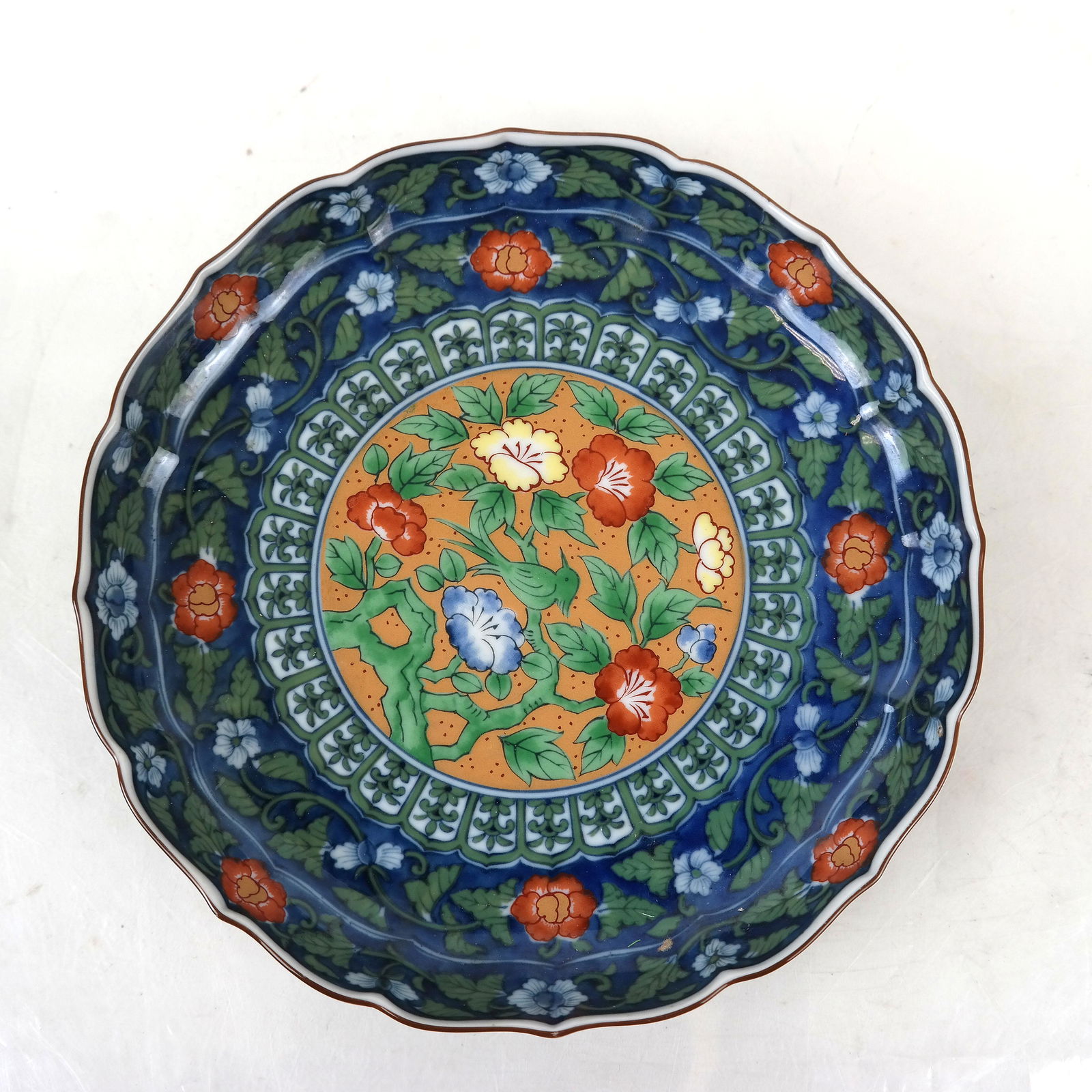 Chinese Scroll Dish: Colorful Chinese scroll dish, with scalloped rim, signed. [7" Diam.]. In good condition.