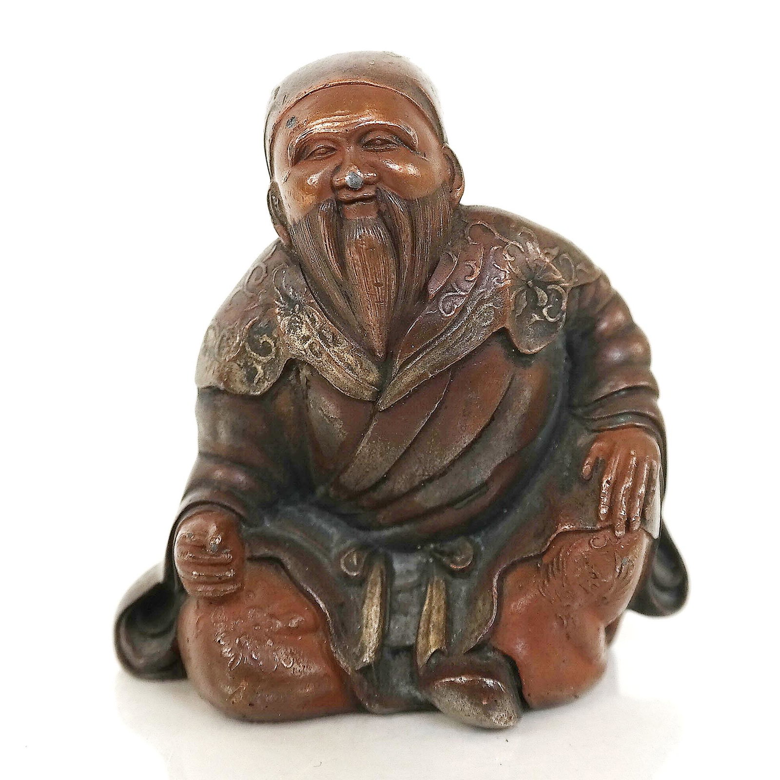 Small Japanese Bronze Sage Figure: Small bronze figure of a seating, smiling sage. [2 1/2" H].