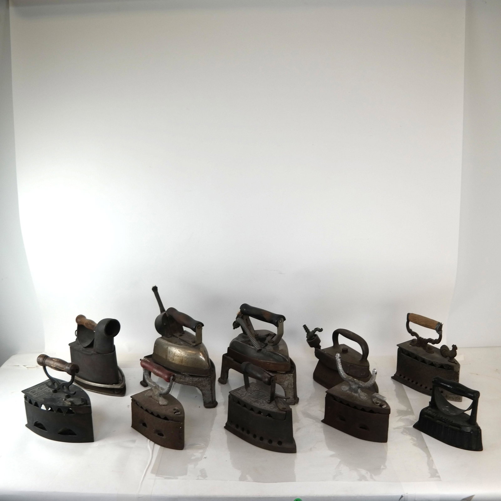 Ten vintage Irons: Mostly two-part irons with detachable tops or handles. Two electric "as-is".