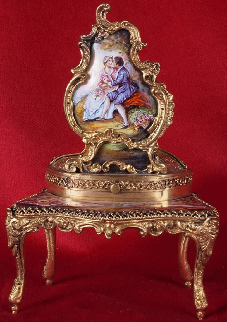 French Miniature Carillon: A delicious and delicate French miniature carillon with a romantic scene of a young couple in the garden romantically whispering. The table has a beautiful romantic scene painted on the enamel featuri