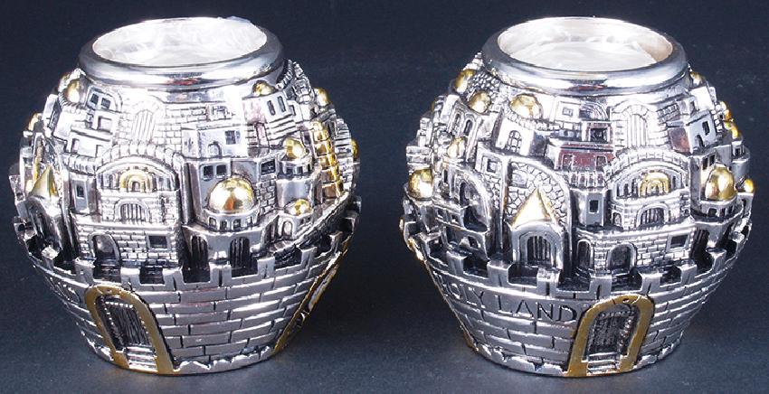 Pair Israeli Candle Holders: An original pair of Israeli Karshi Jerusalem Candle Holders. Circa 1955. Comes in original packaging, comes with two candles as well. These fine pieces of Judaica feature motifs of Jerusalem and Israe