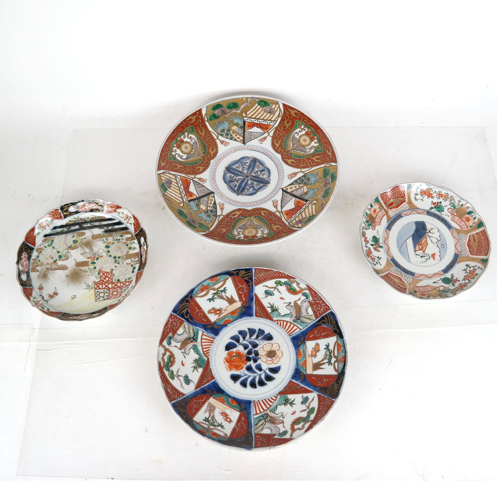 Four Chinese Decorated Plates: Two Chinese decorated plates and two chargers. [Largest: 12" Diam.]. In good condition.
