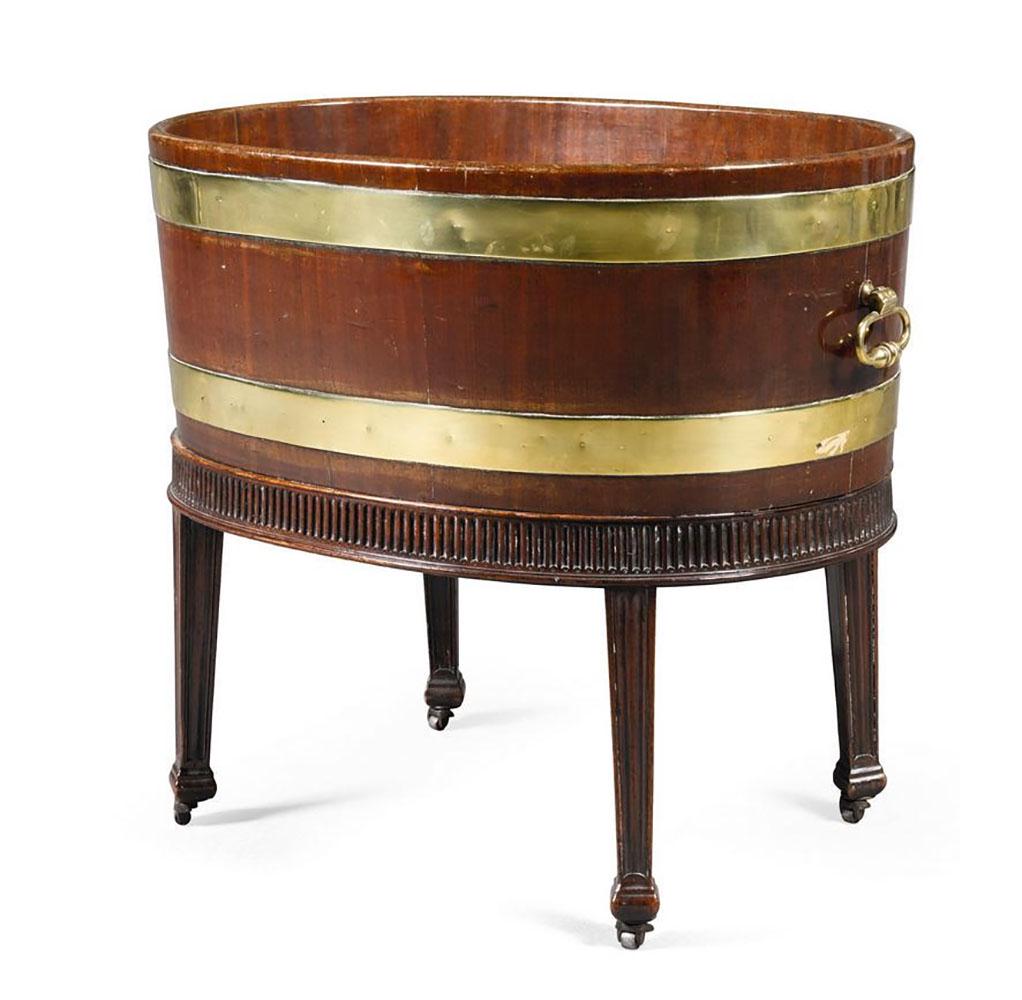 18th C. George III Mahogany Wine Cooler: A George III brass mounted mahogany wine cooler, last quarter 18th century, in the manner of Thomas Chippendale, with a later lead liner, on later metal castors. Provenance: Sotheby's, London "Collect