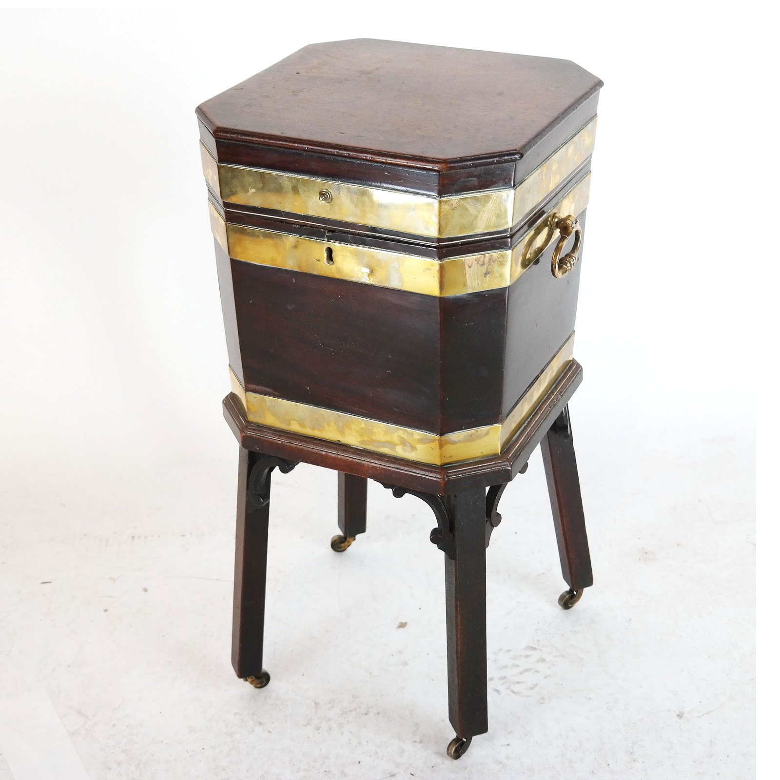 George III Mahogany Wine Cooler, Circa 1760: A George III brass bound mahogany wine cooler, circa 1760, the hinged top enclosing a later lead liner with gilt-brass carrying handles. Provenance: Sotheby's, London "Collections" sale, October 26, 2