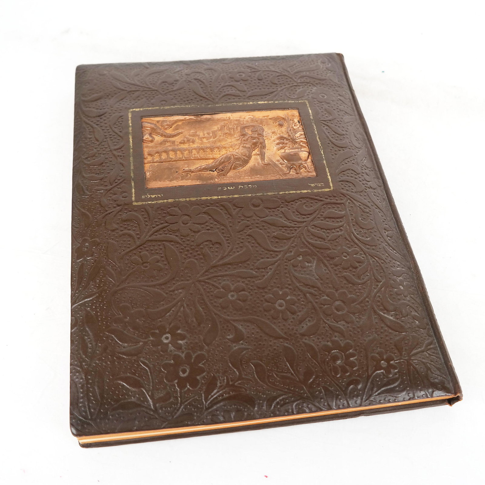 Song of Solomon: Tooled faux leatherbound book in Hebrew, with inlaid copper relief plate inlay panel with reclining female figure. titled ‘The Song of Solomon; In Coloured Plates’", with plates by Zeev Raban. Pub