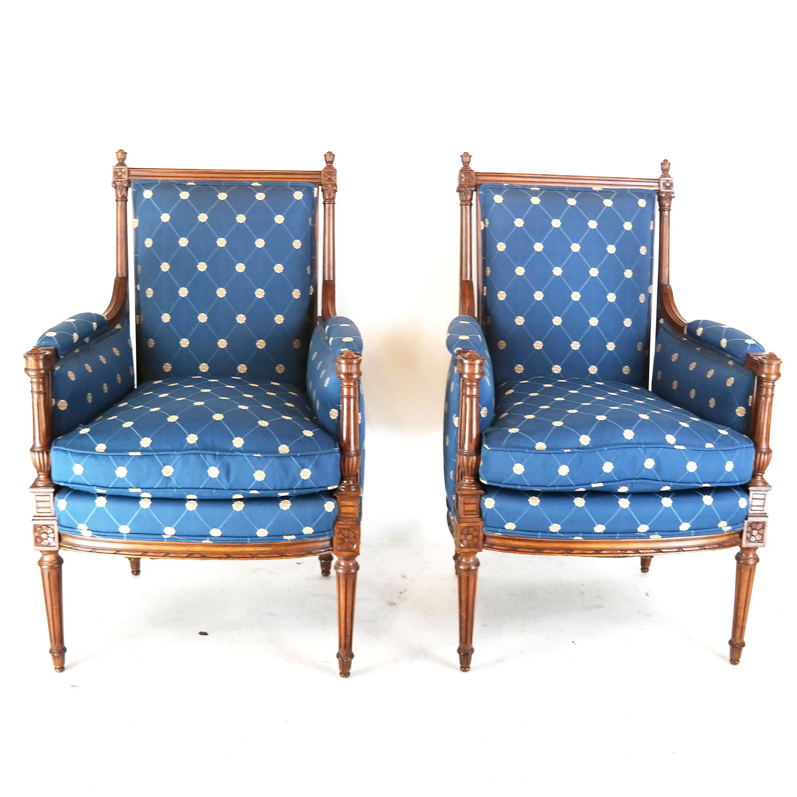 Pair French-Style Blue Upholstered Bergeres: Pair of French-style blue upholstered bergeres, with acorn finials. [42" H x 26 1/2" W x 22 1/2" D; 24" to seat].