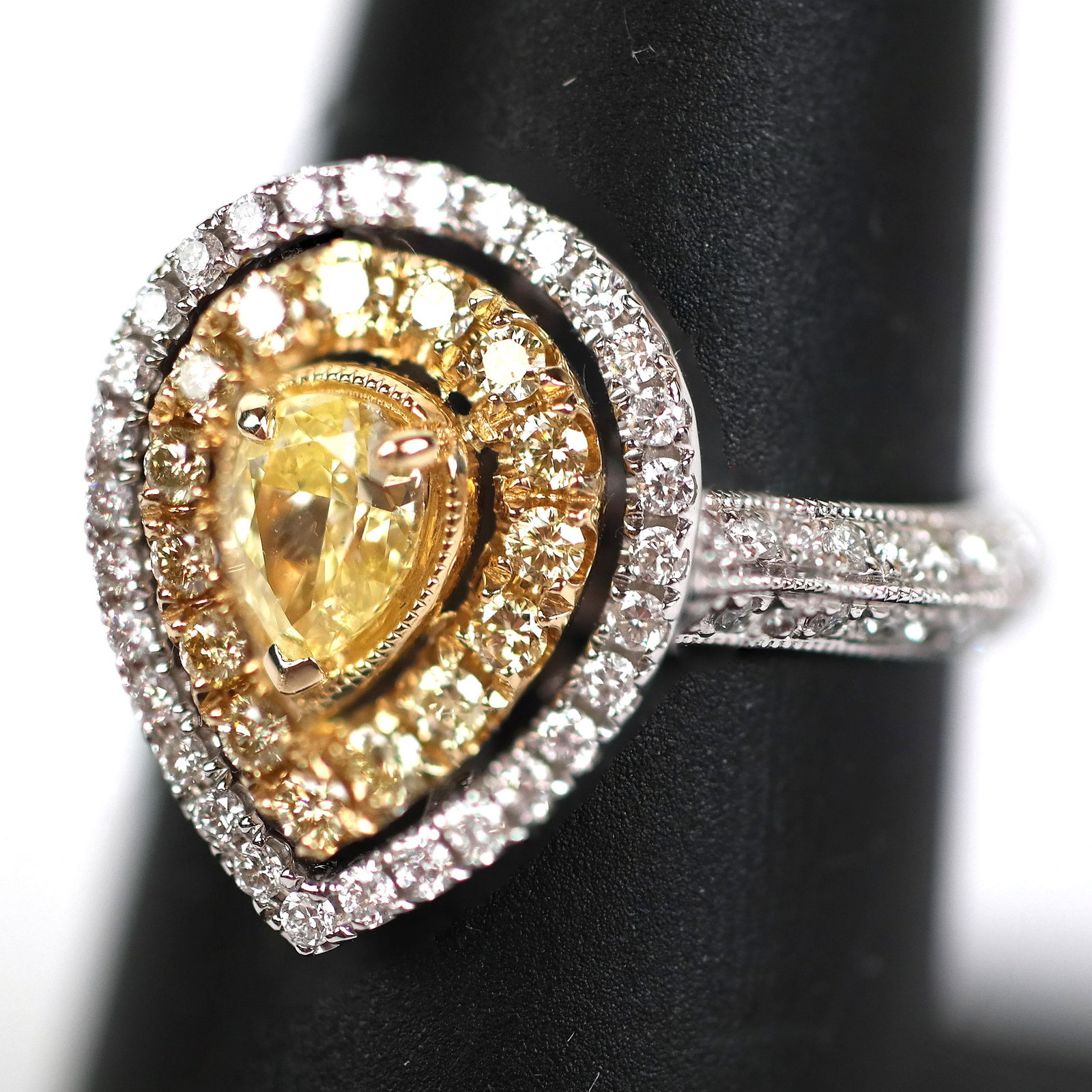 Yellow Diamond Ring: 0.54 ct Yellow Diamond Pear and 0.46 ctw diamonds in 14K two-tone gold setting. Yellow diamond 0.29 ctw. Size 7. In very good condition.
