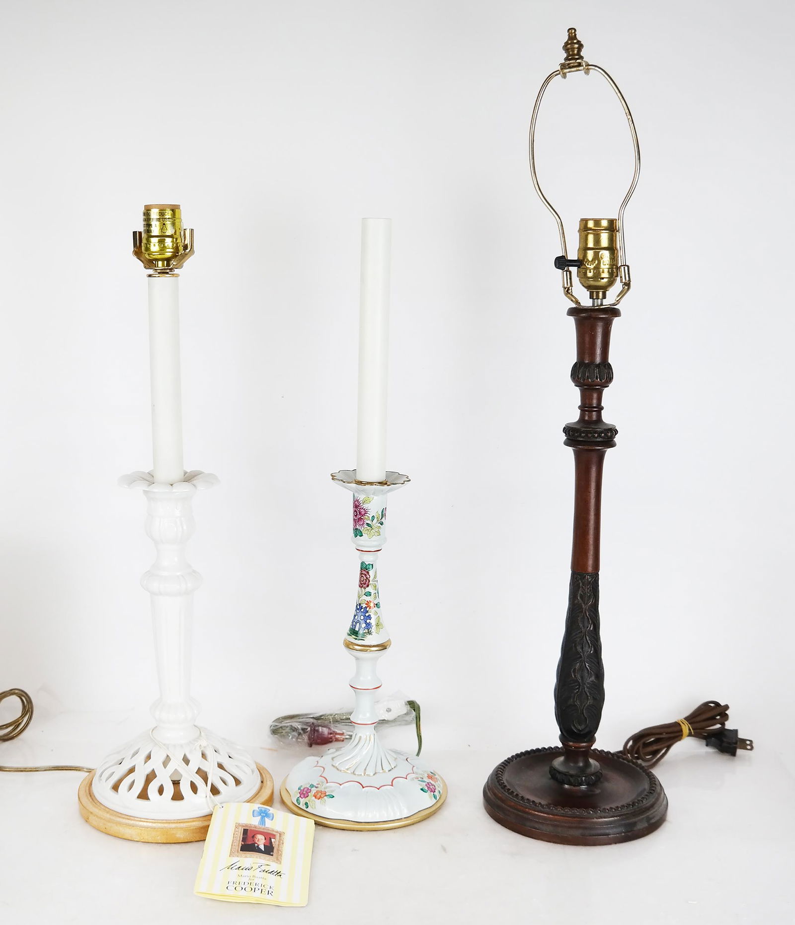 Three Decorated Lamps: A wood feather design, a porcelain lamp by Mario Buatta for Frederick Cooper and a floral decorated porcelain lamp. Provenance: From the Upper East Side estate of a prominent NYC interior decorator. [