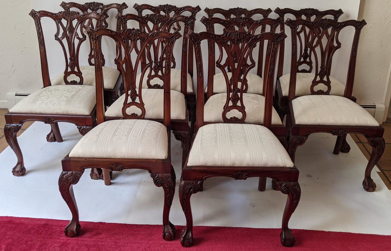 Set of 10 Chippendale-Style Side Chairs: Set of carved mahogany side chairs with cabriole legs, claw and ball feet and slip cushions. [Each: 40" H x 23 1/2" W, x 23 1/2" D]. In good condition.