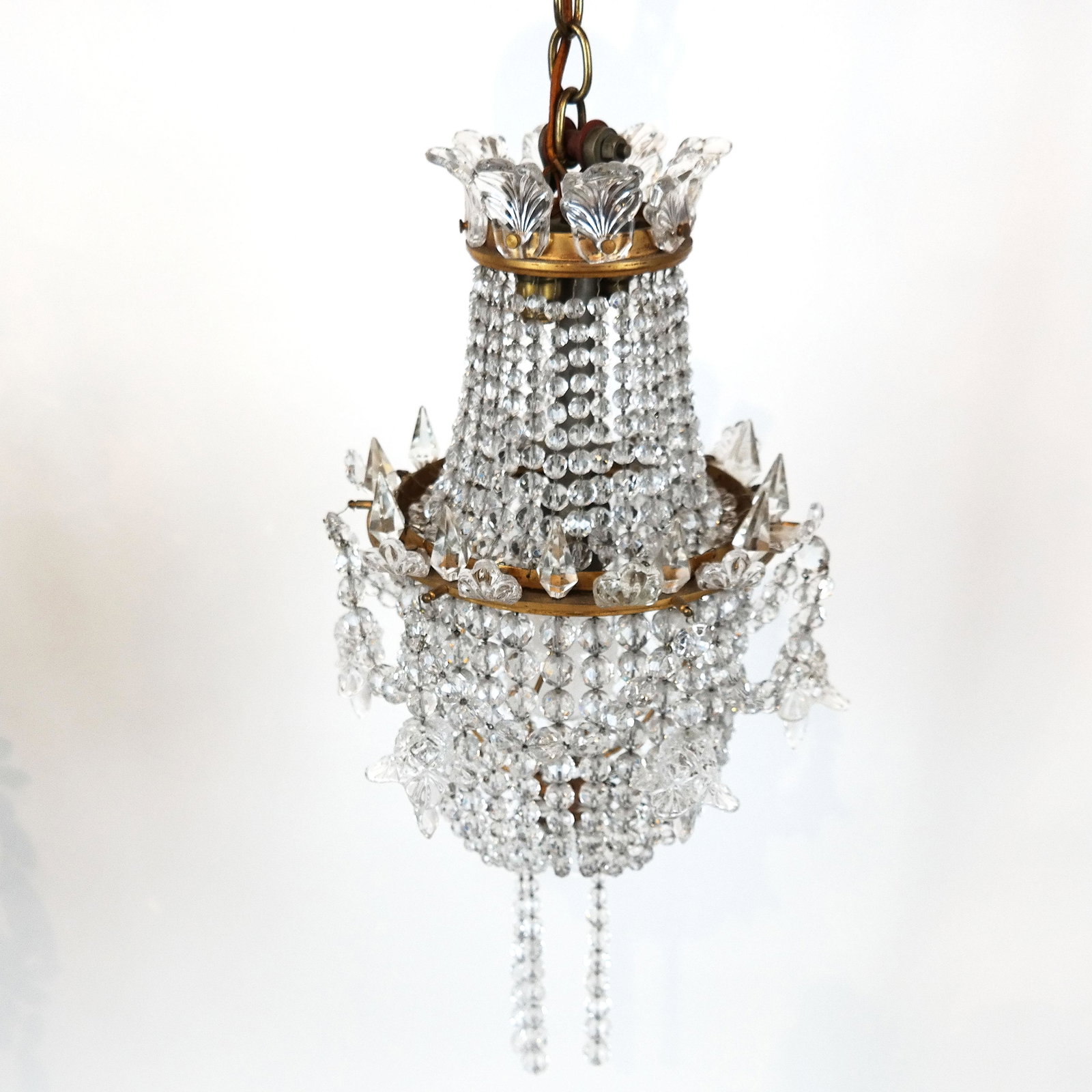 Crystal and Bronze Pendant Chandelier: Small bronze and crystal chandelier. [25" H x 10" Diam.]. A few crystals missing.