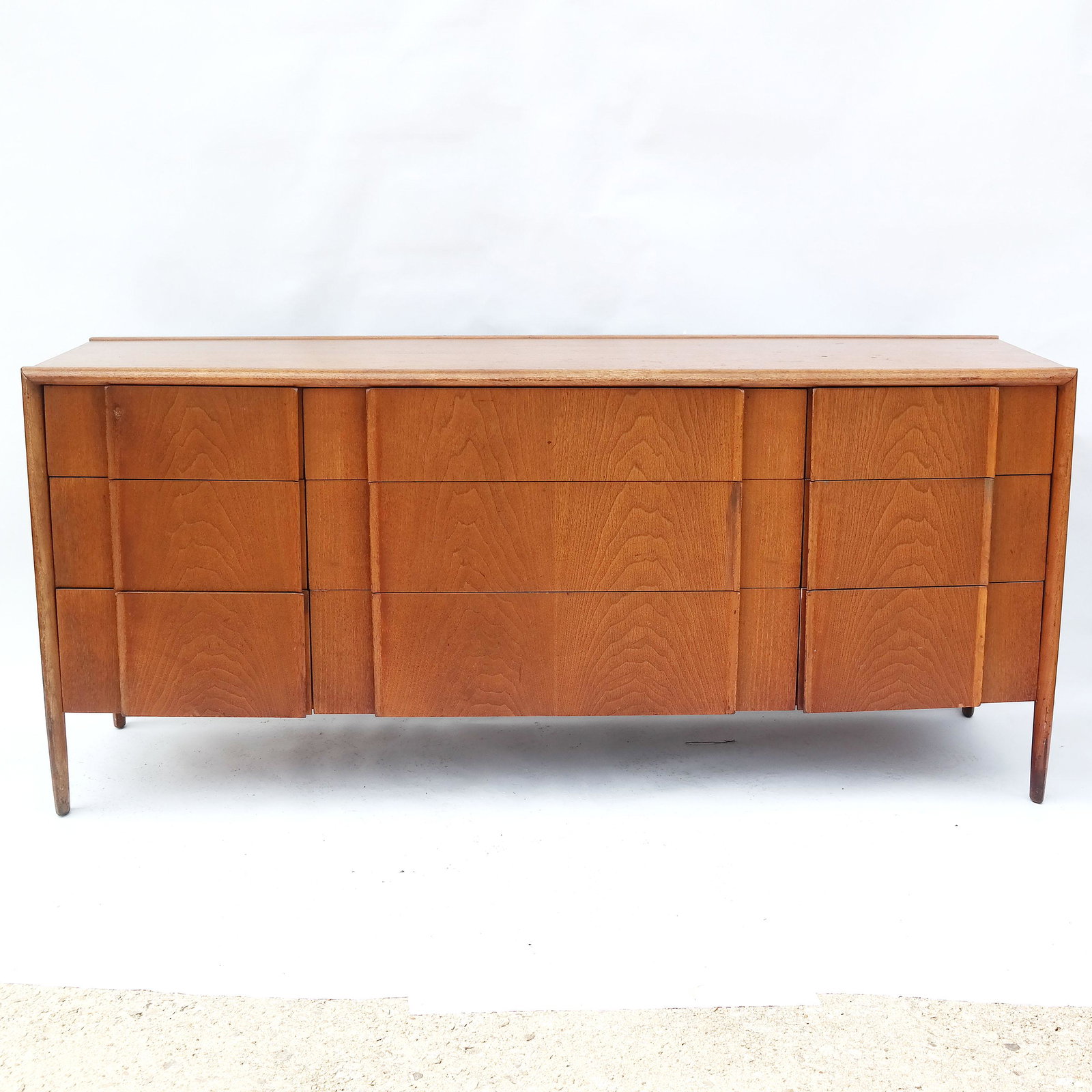 Drexel Mid-Century Modern Dresser: Drexel walnut Mid-Century Modern bedroom dresser. Stamped inside. Matches lots 108, 110, 122 and 184. [32" H x 72" W x 20" D]. Wear; stains to top.