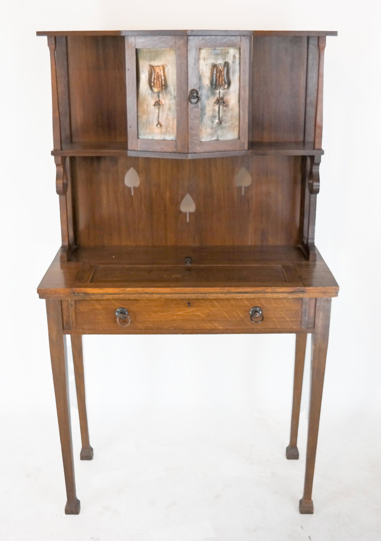 Arts & Crafts Oak Secretary: Oak secretary with brass repousse accents. [56" H x 32" W x 15" D]. In good condition; wear to finish.