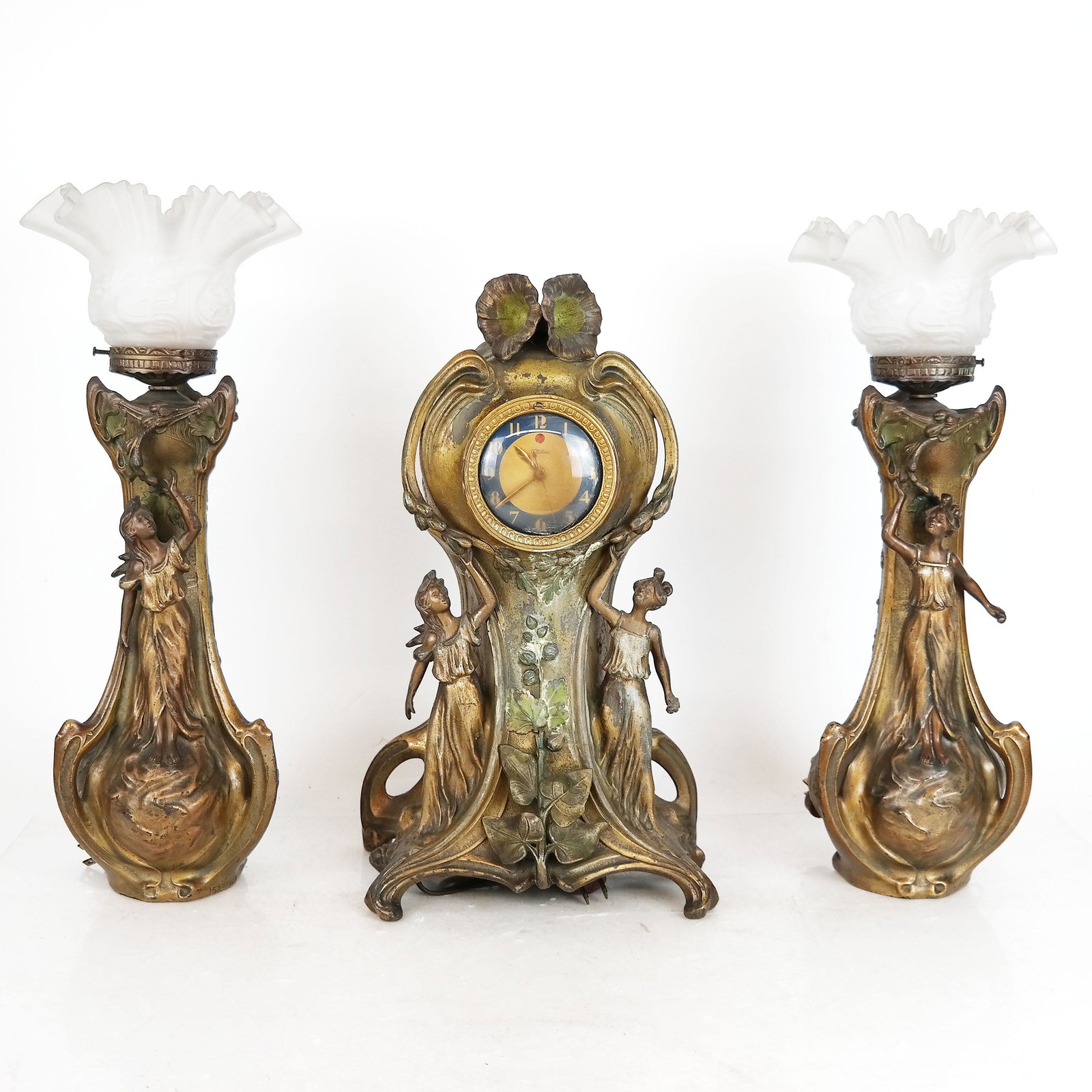 3-Piece Art Nouveau Mantel Garniture: Female figural design, vasiform, with upturned, frosted shade lamps and matching clock (works by Telechron). [17" H x 7" Diam.].