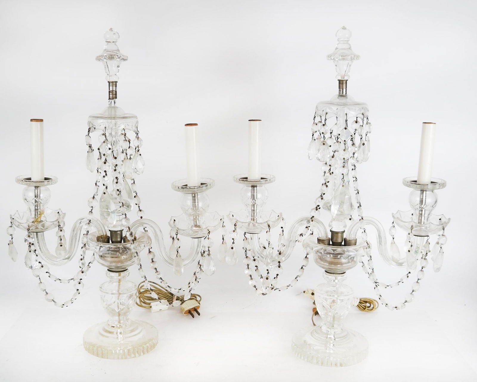 Pair of French Crystal Girondoles: Pair of girondoles, with crystal garlands and prisms; electrified. Provenance: From the Upper East Side estate of a prominent NYC interior decorator. [20" H x 13 1/2" W x 4 3/4' D]. In good condition;