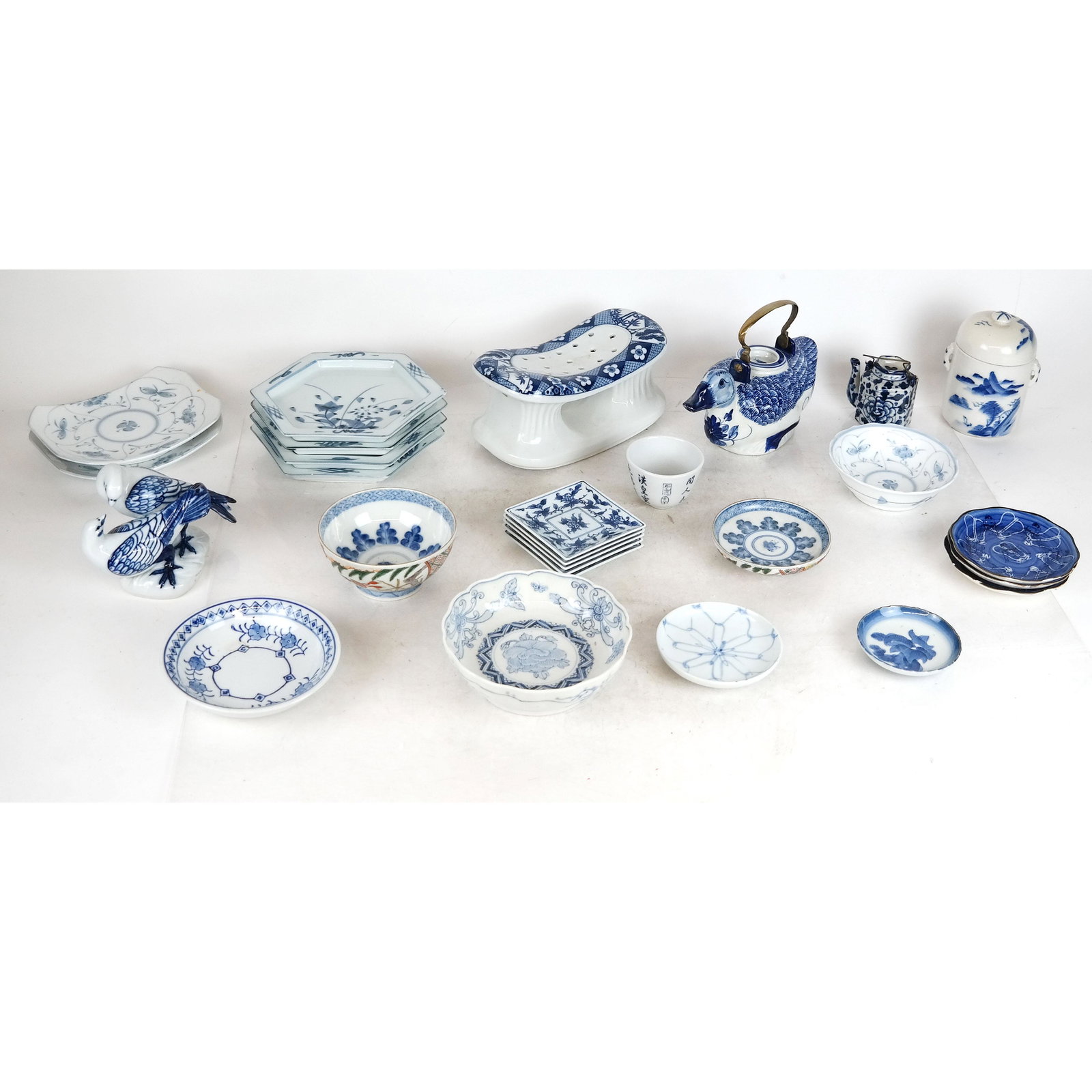 Large Lot of Chinese Blue & White Porcelain: Chinese porcelain lot including plates, bowls, teapots and a porcelain pillow.