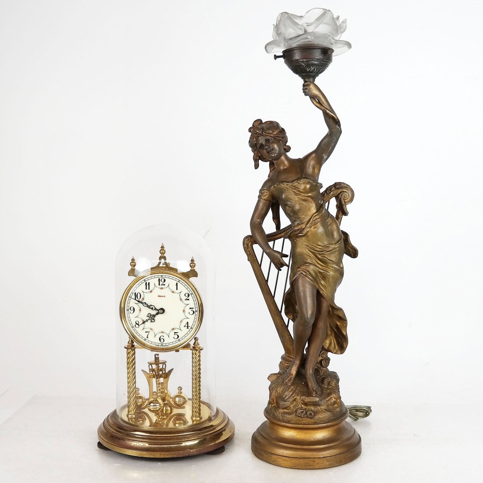 White Metal Lamp and Clock: Art Nouveau gilt metal female figural lamp and bronze clock under dome. [Lamp: 23" H].