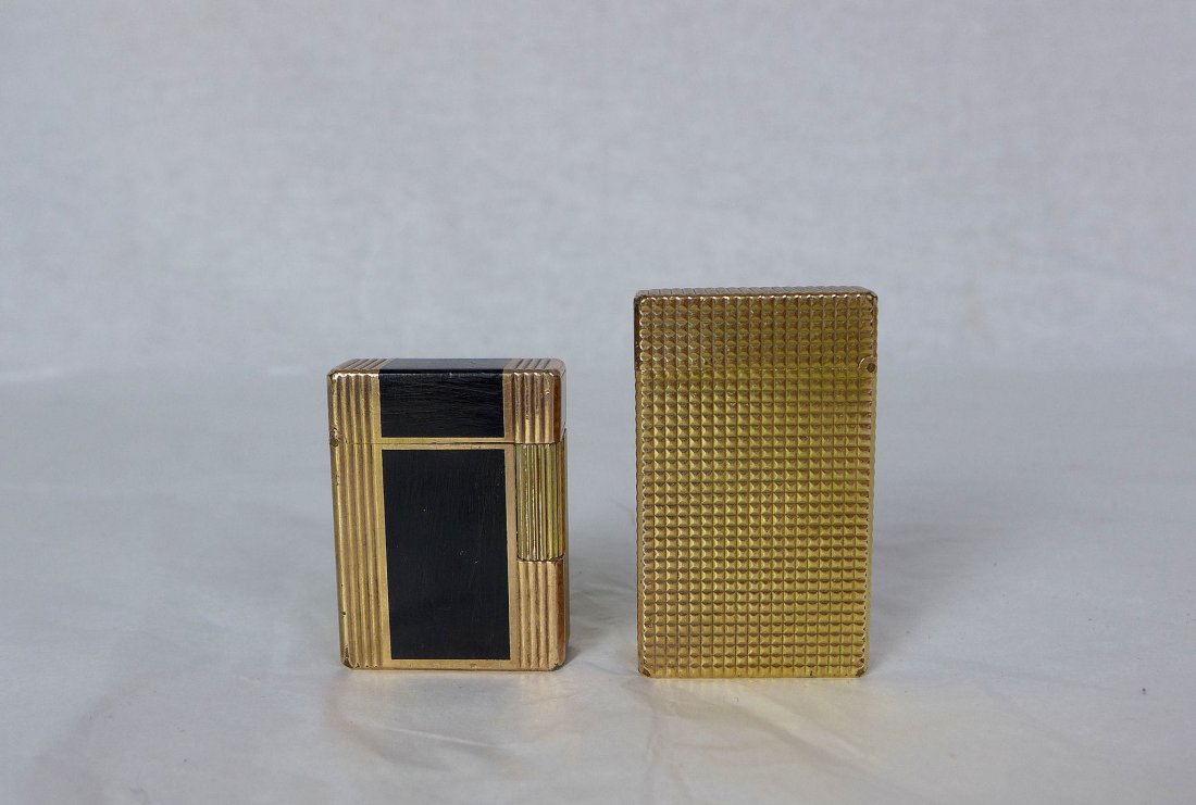 S Dupont Paris French Gold Lacquer Lighters: Two vintage S Dupont Gold Plated Lighters .One with black lacquer the other with pyramid cut design, In vintage condition with wear and age .