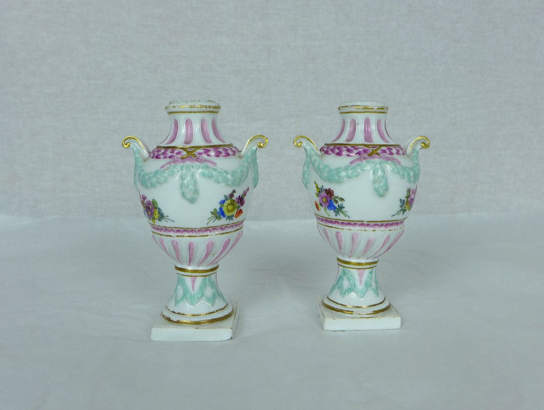 Pair of Meissen Porcelain Miniature Vases: Pair of Antique Porcelain Vases. Meissen miniature porcelain Urns decorated with a Pink and blue floral design. Signed underneath small chip on base corner and losses to gilding and paint. Measures 4.
