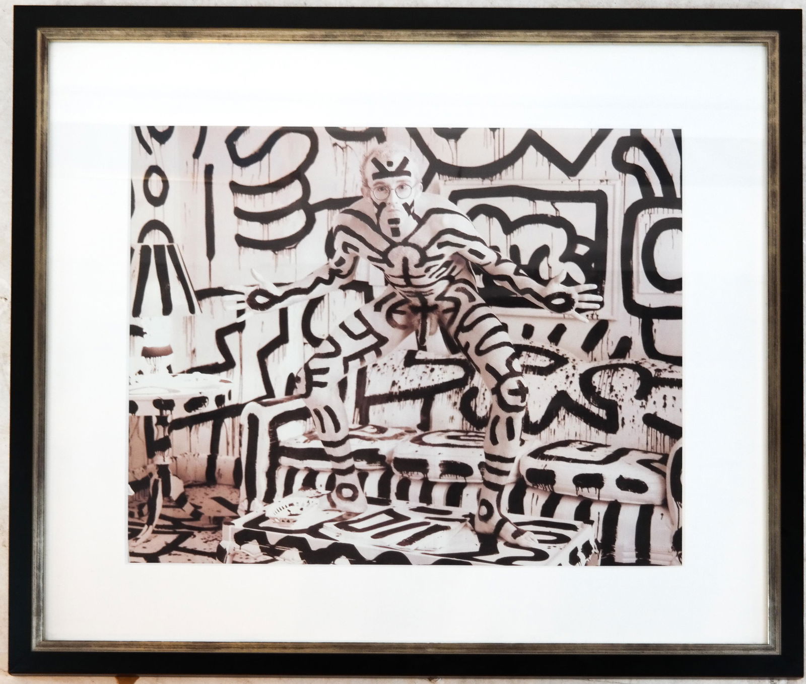 Annie LEIBOVITZ (b. 1949): Keith Haring - Print: Print of Keith Haring, NYC, nude, painted in black & white against a matching interior, after the photo by Annie Leibovitz. Printed later. [Sheet: 21 3/4" H x 27"" W; Frame: 29 1/2" H x 34" W]. Print