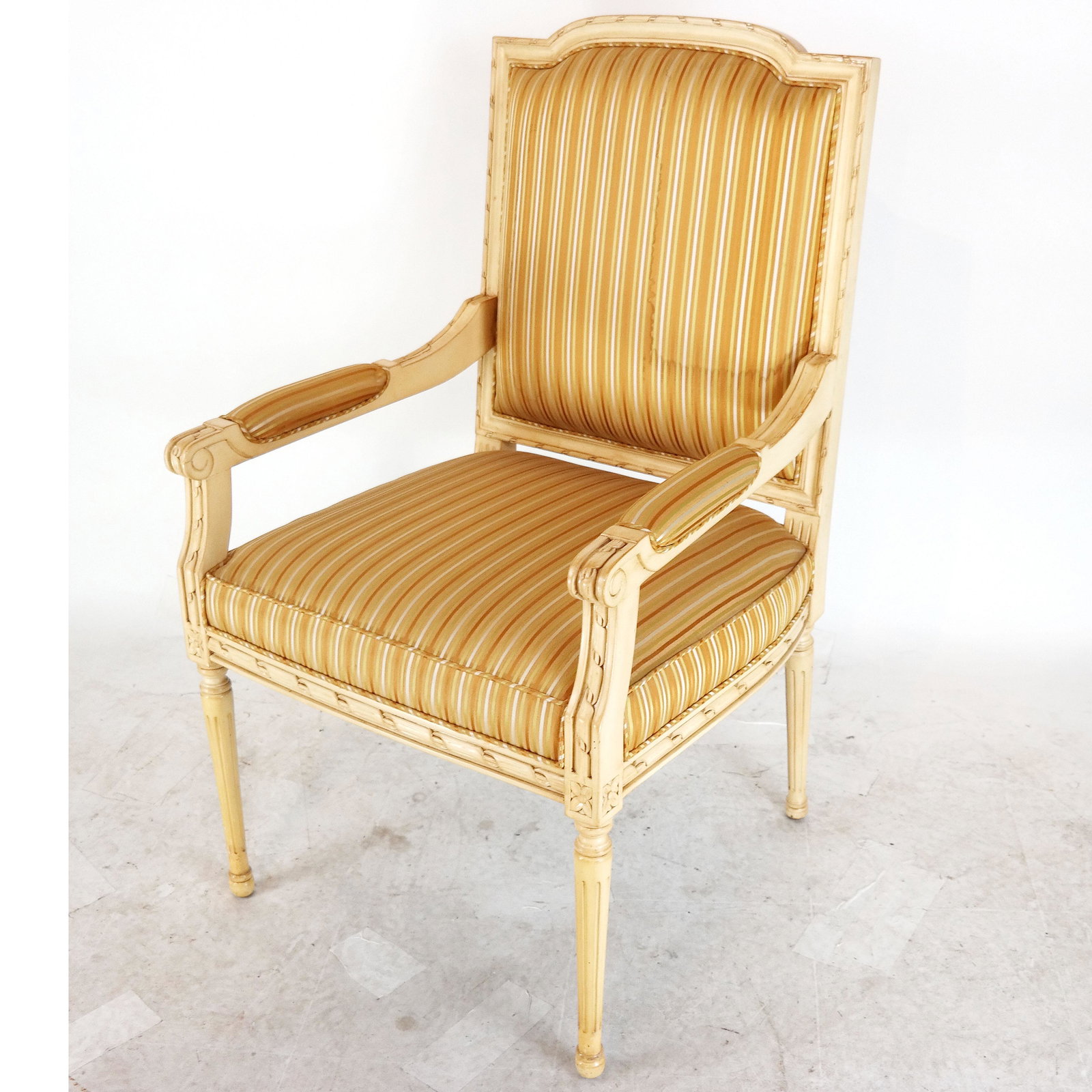 Louis XVI-Style Painted Arm Chair: Cream painted and upholstered arm chair, late 20th century. [42" H x 24" W x 24" D]. Water stained fabric.